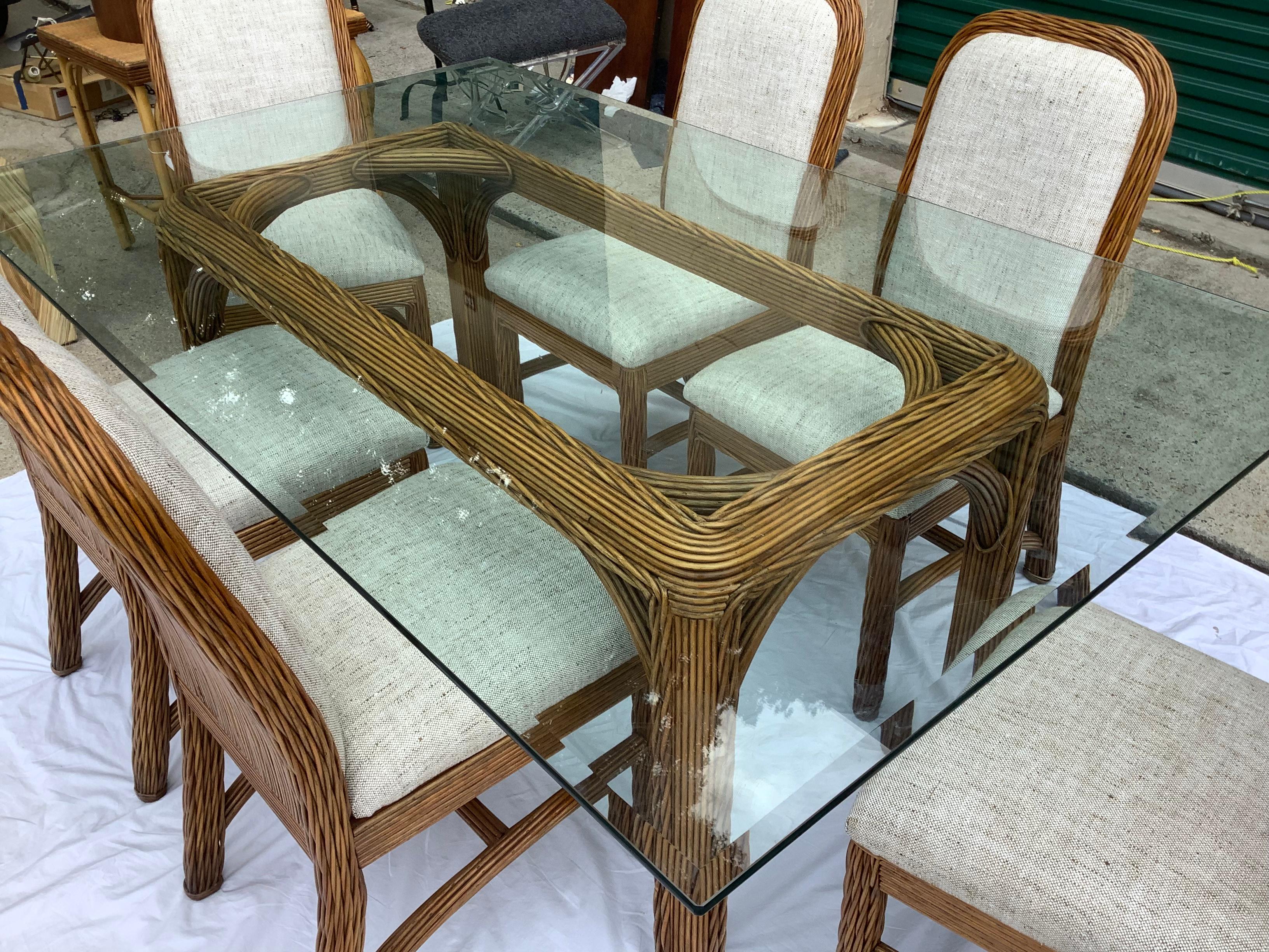 Very handsome , woven reed table base w/ glass top, and 8 matching , woven reed chairs; 2 arm chairs, and 6 side chairs. Chairs and table base are well made, sturdy, and have some weight to them. Chairs and table base, have been cleaned and clear
