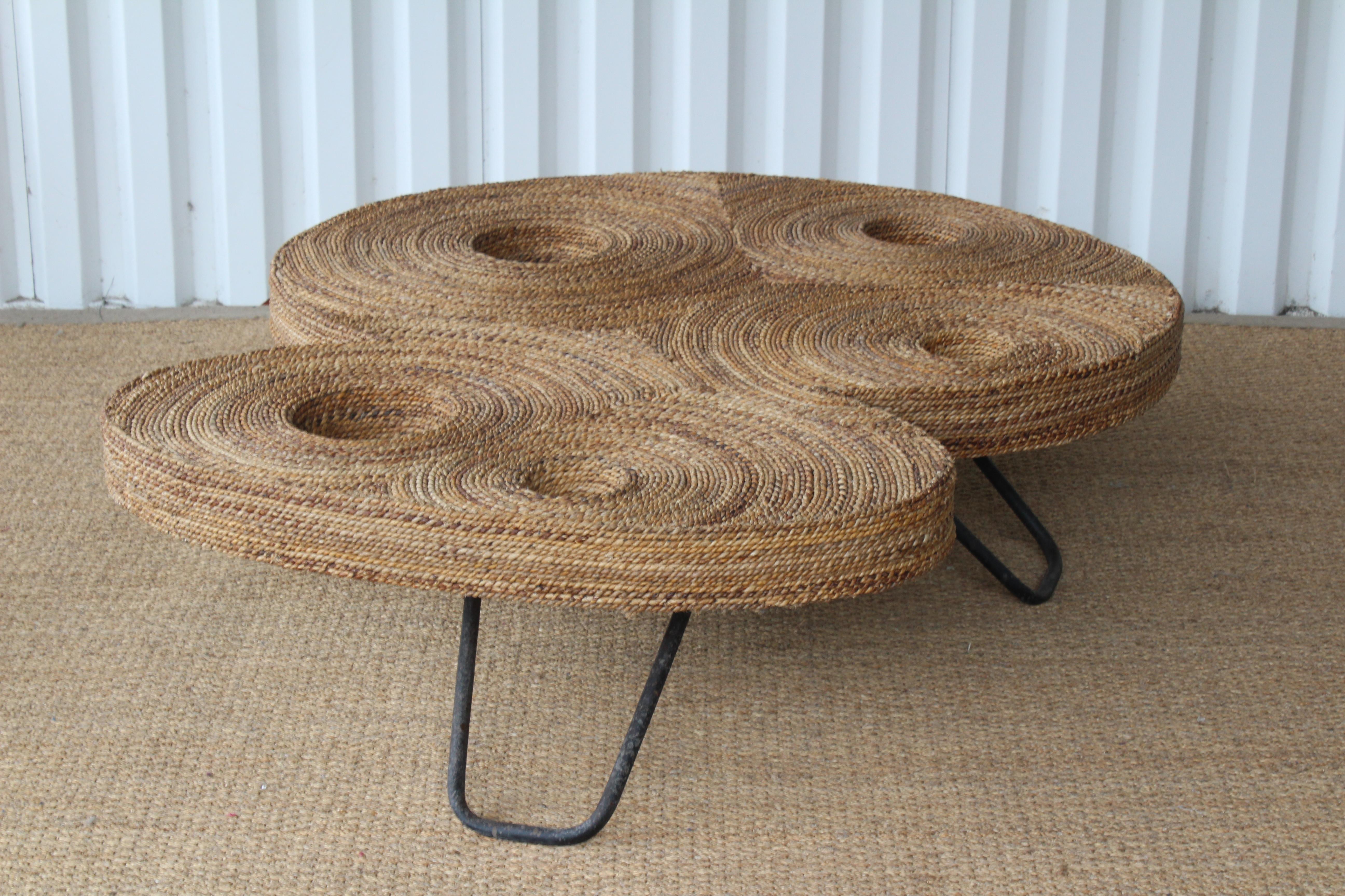Unique and unusual woven rope wrapped coffee table on iron base. Unknown make and designer.