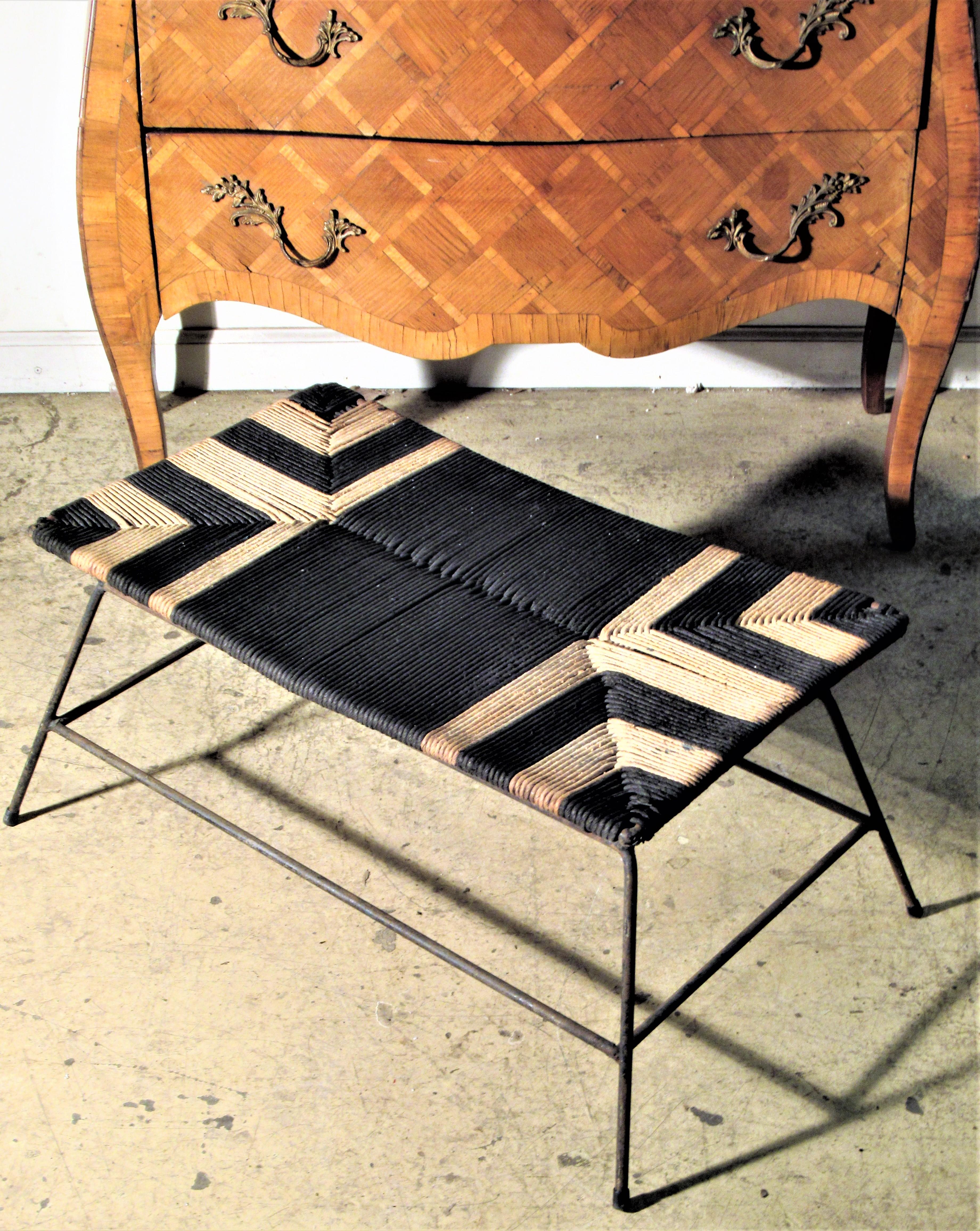 Sculptural modernist iron stool with a graphic tribal like designed hand woven fabric rope seat, circa 1950s. Great looking. Look at all pictures and read condition report in comment section.