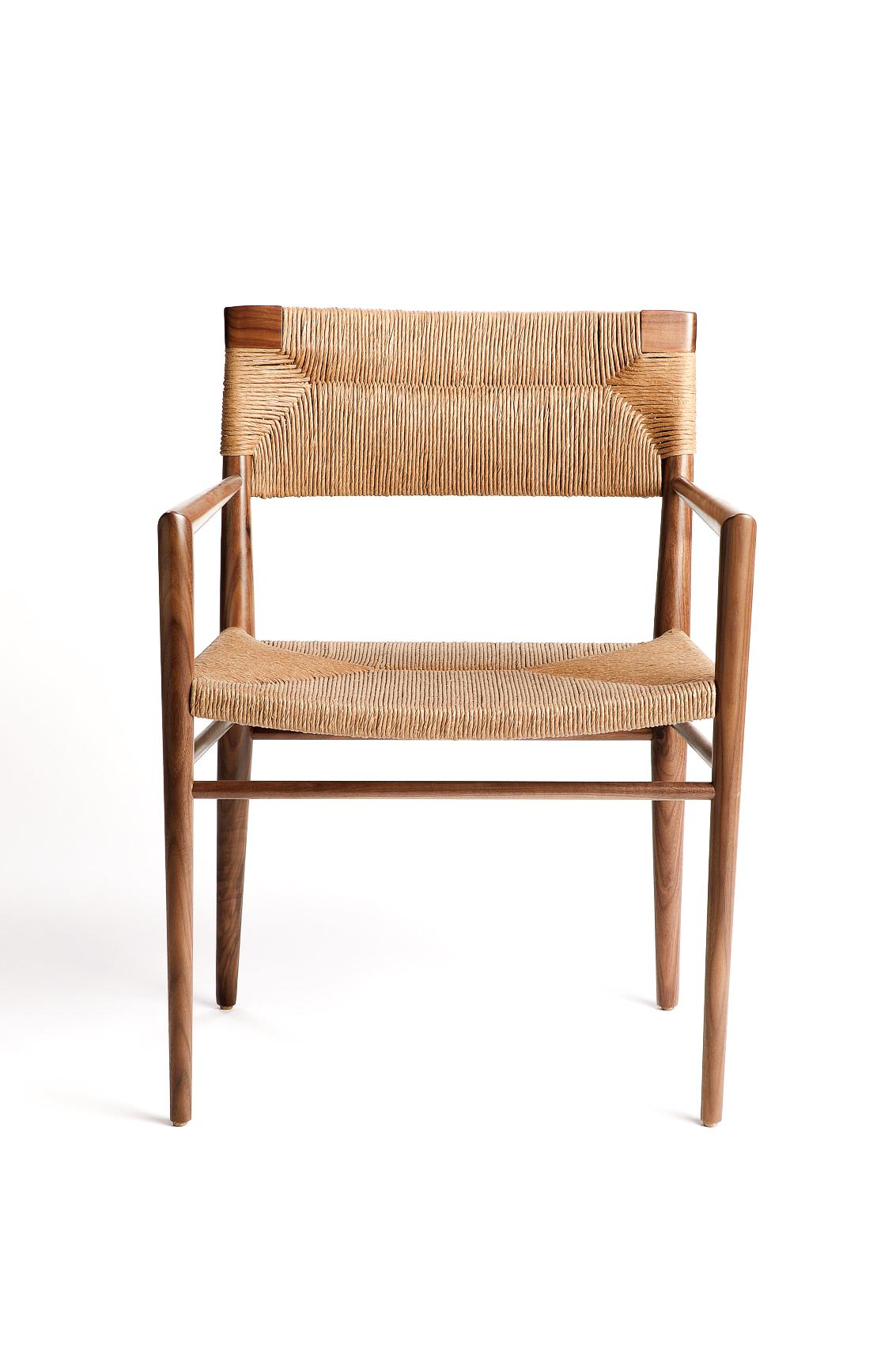 Originally designed by Mel Smilow in 1956 and officially reintroduced by his daughter Judy Smilow in 2018, the woven rush-backed dining armchair is classically midcentury. This collection’s handwoven seating and handcrafted wooden frame provide a