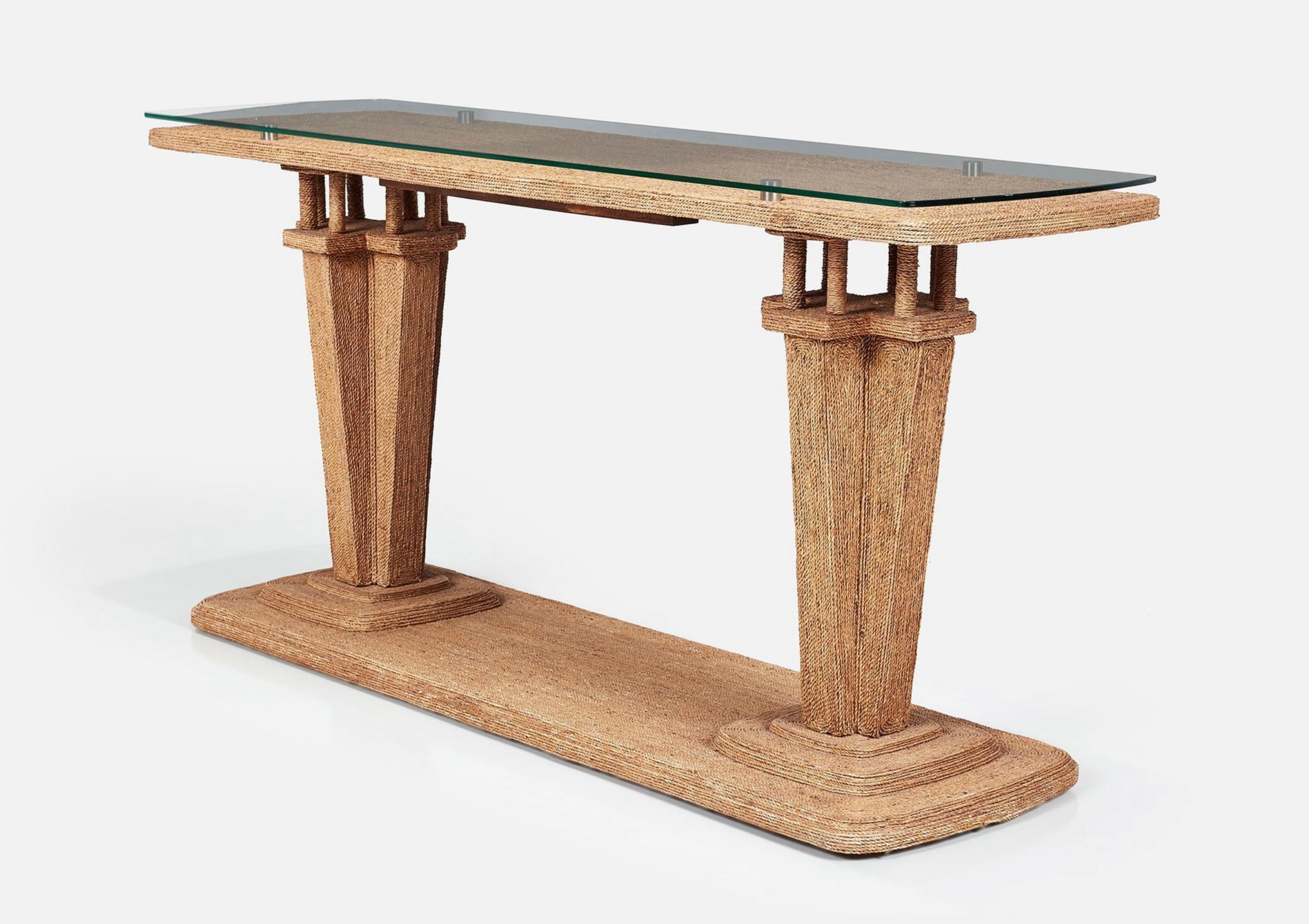 A beautiful woven seagrass console table by the Century Furniture company. It features four metal supports and a glass top. The piece is quite elegant in its simplicity of design. Perfect for an entryway or hallway. 
It retains the manufacturer’s
