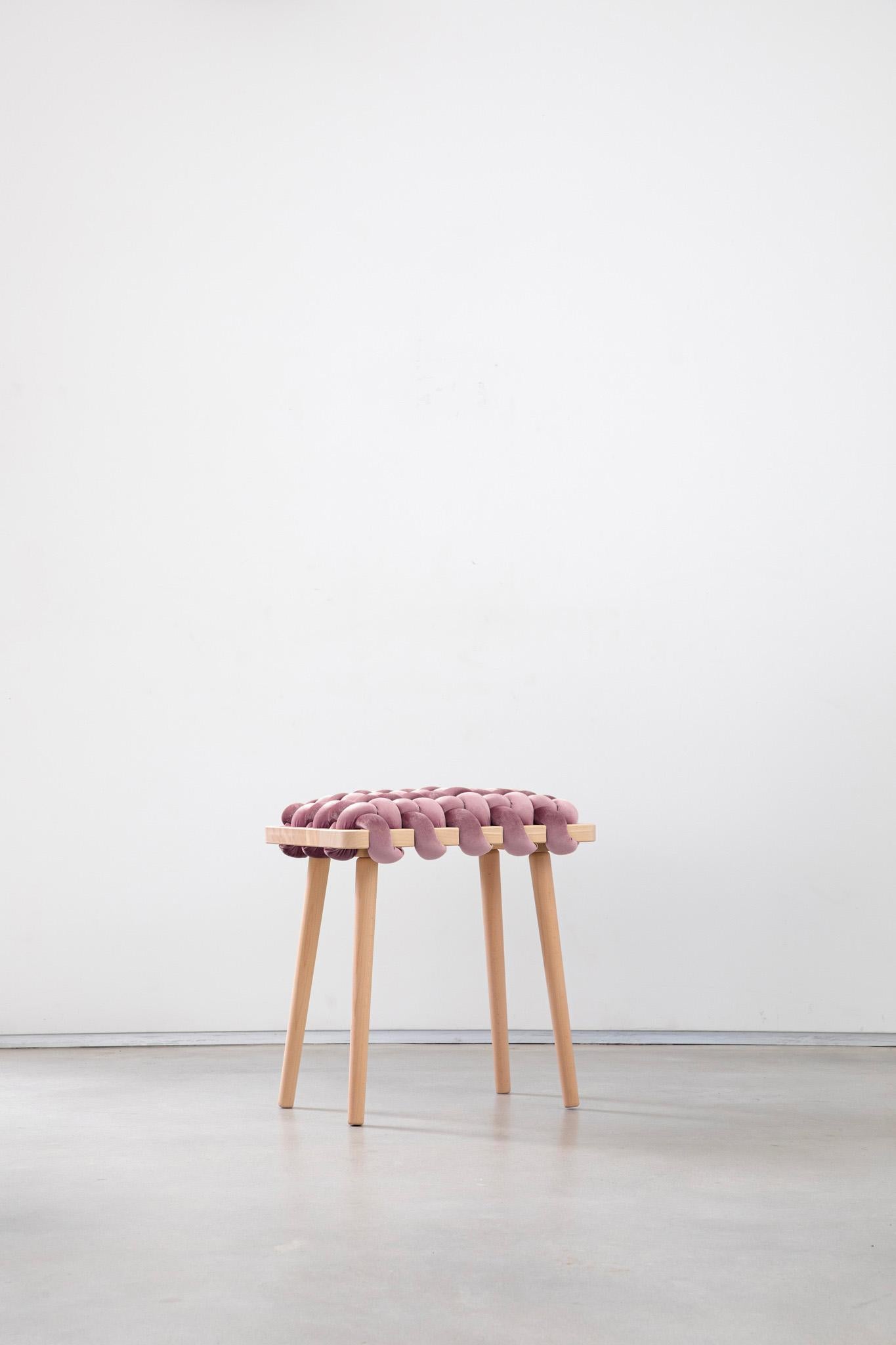 Expertly crafted with a blend of fine velvet fabric and natural Beechwood, the hand-woven stool enhances any entryway or living space with its elegant and playful design. This lasting piece combines beauty and functionality, creating a stunning