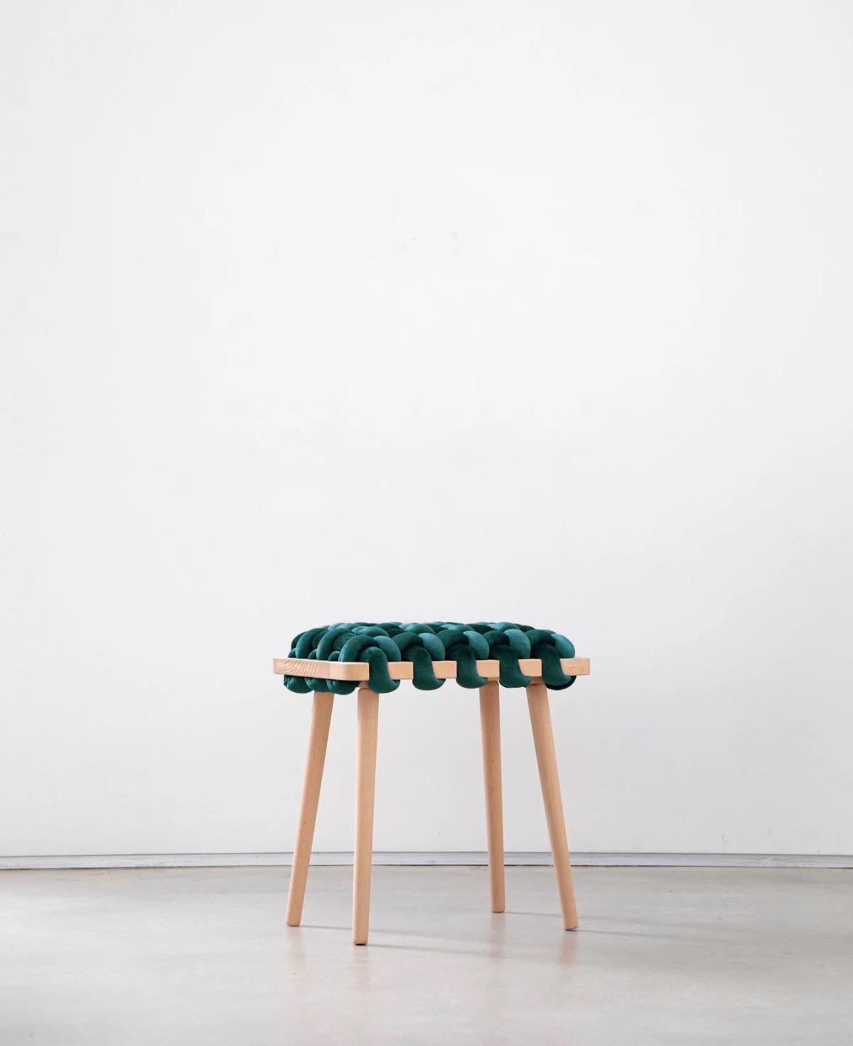 Expertly crafted with a blend of fine velvet fabric and natural Beechwood, the hand-woven stool enhances any entryway or living space with its elegant and playful design. This lasting piece combines beauty and functionality, creating a stunning