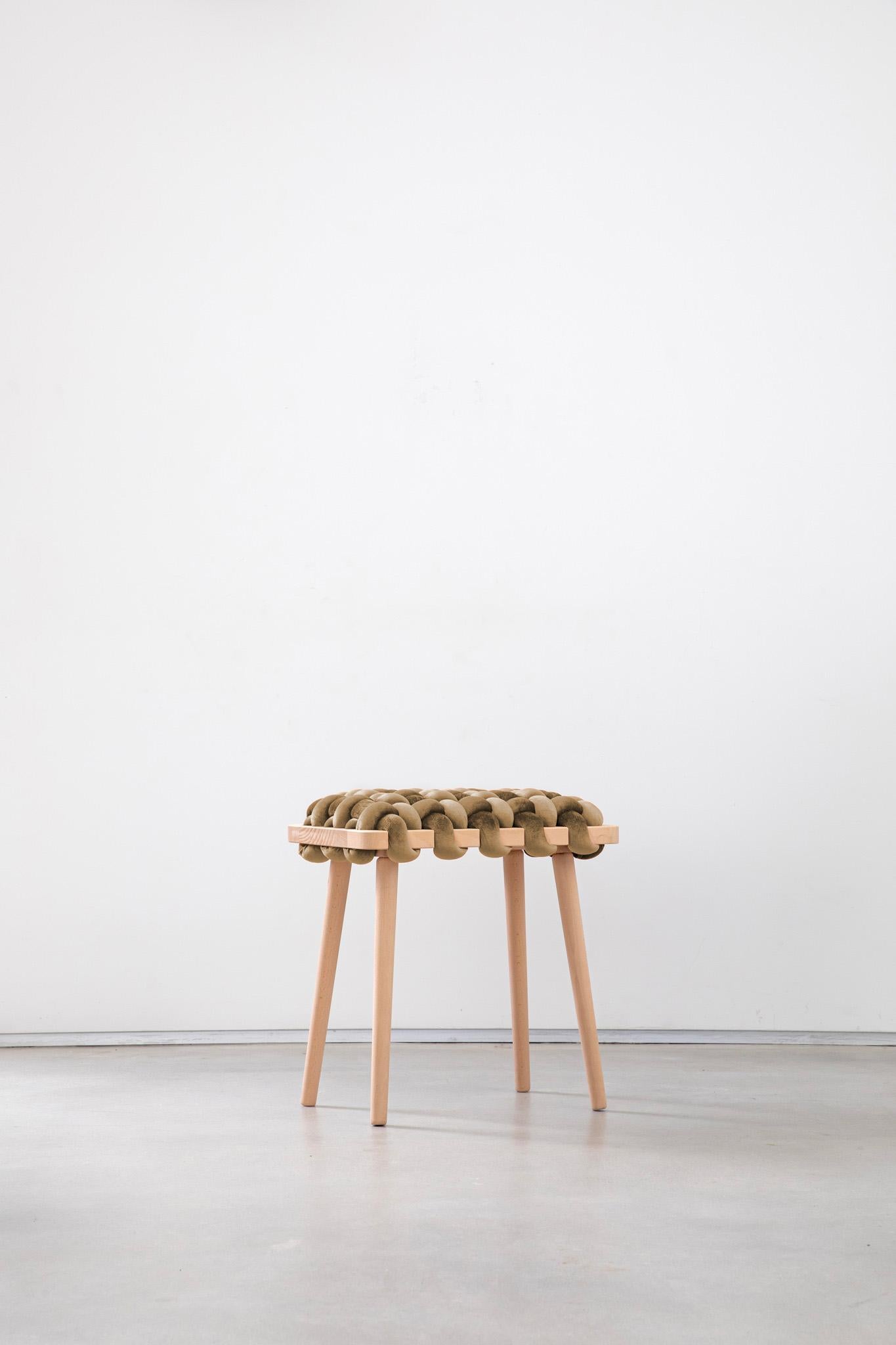 Expertly crafted with a blend of fine velvet fabric and natural Beechwood, the hand-woven stool enhances any entryway or living space with its elegant and playful design. This lasting piece combines beauty and functionality, creating a stunning