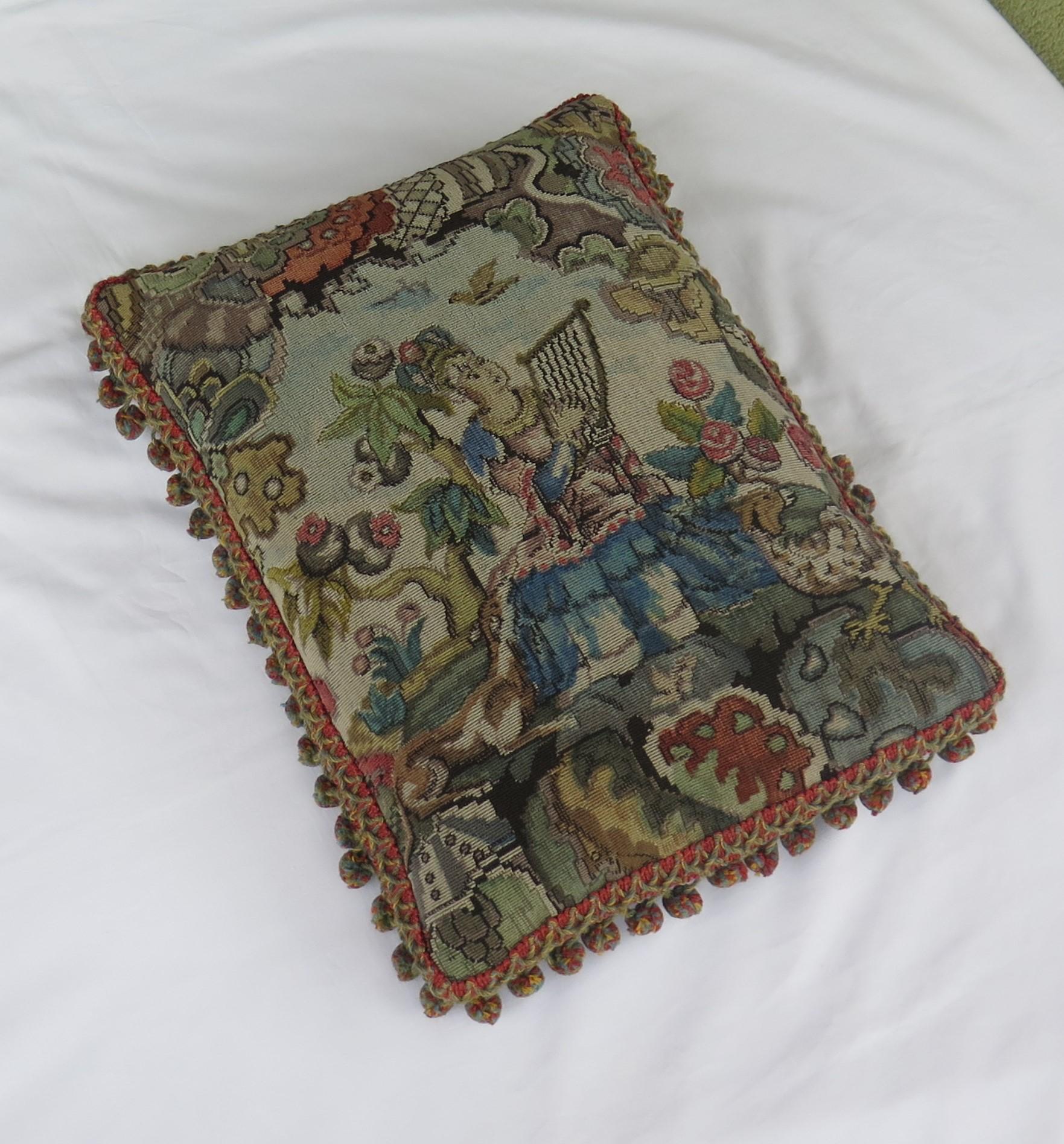 This is a beautiful woven tapestry pillow or cushion depicting a Lady playing a Lyre in a woodland setting, all in the Aubusson style, with a pom pom wool fringe to the outer edge, which we date to the second half of the 19th century.

The