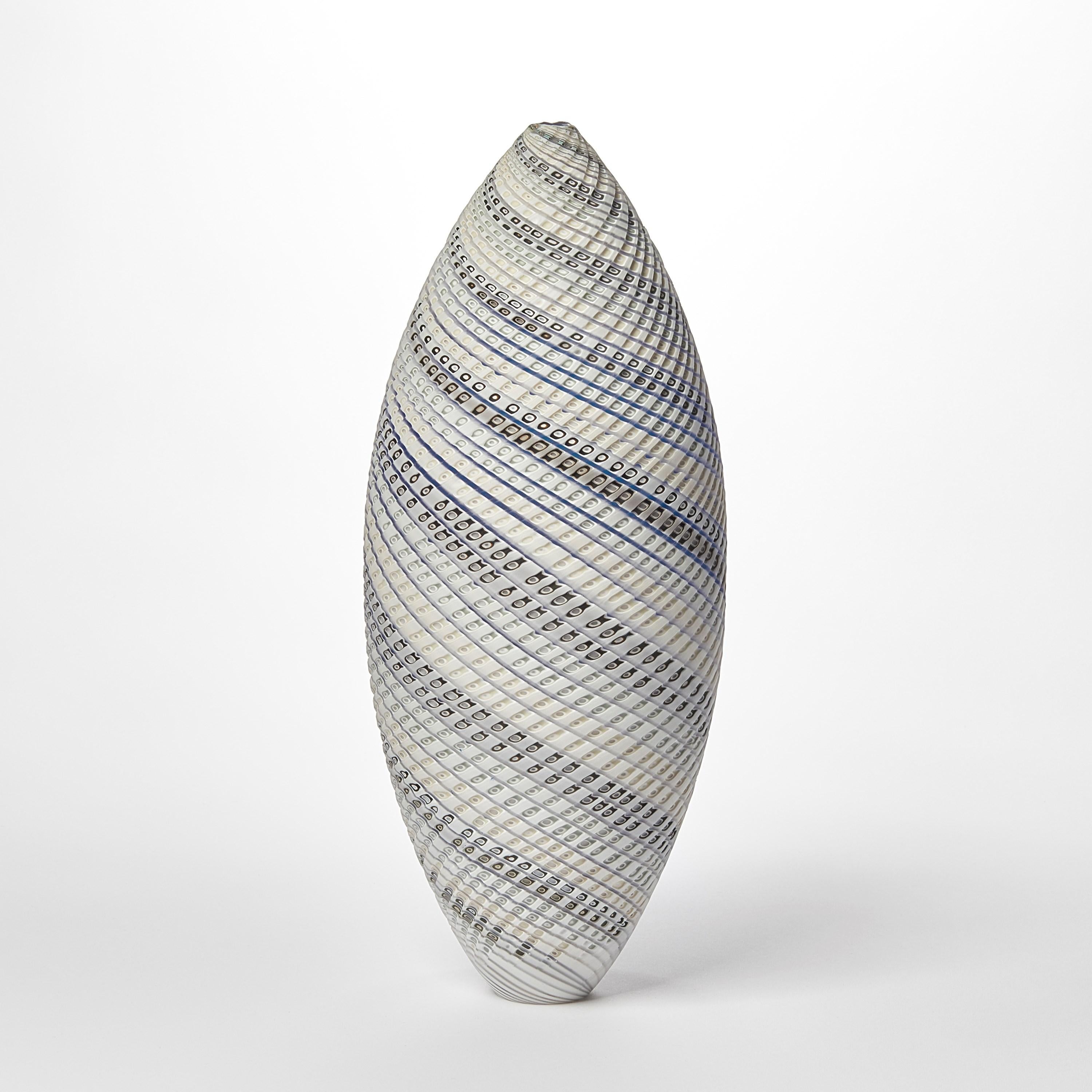 'Woven Three Tone Blue Ovoid (lg)' is a unique handblown, sculpted and cut glass sculpture by the British artist, Layne Rowe.

Rowe’s inspiration is drawn from the dramatic Devon coastline which informs his love for detail, a constant theme for his