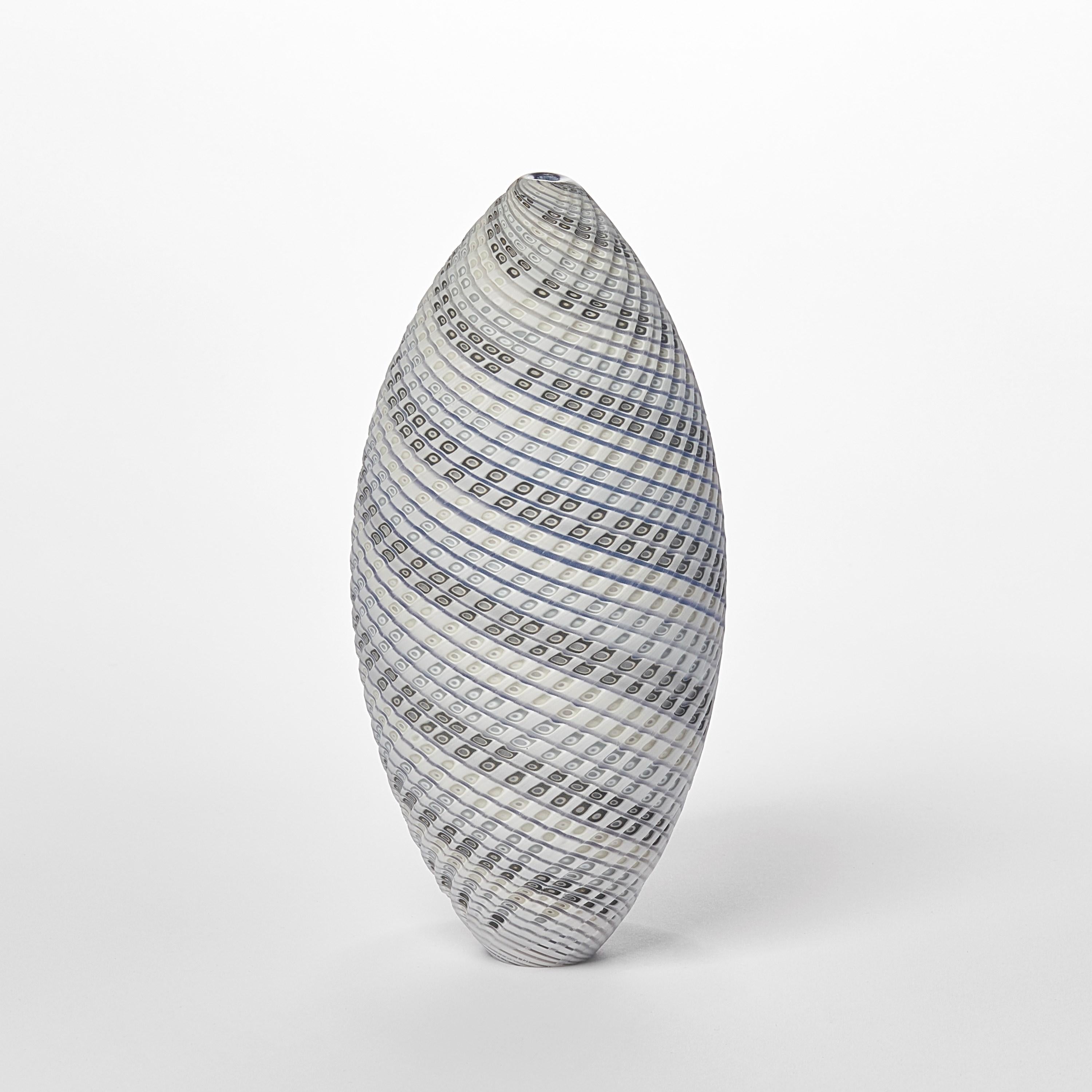 'Woven Three Tone Blue Ovoid (sm)' is a unique handblown, sculpted and cut glass sculpture by the British artist, Layne Rowe.

Rowe’s inspiration is drawn from the dramatic Devon coastline which informs his love for detail, a constant theme for his