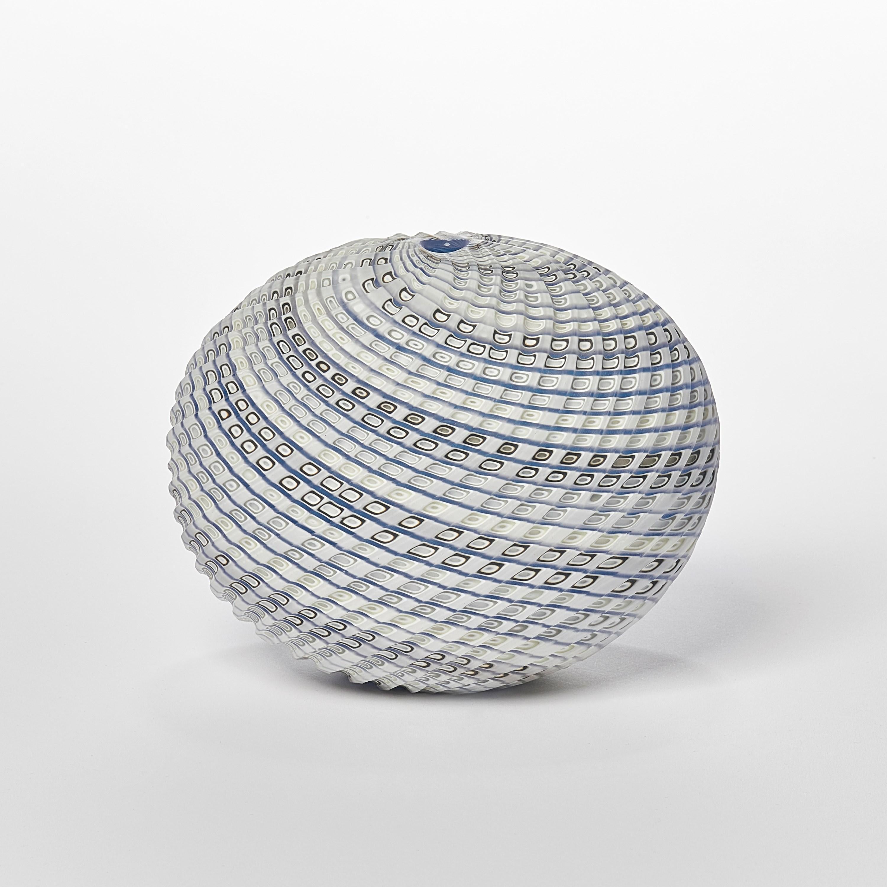 'Woven Three Tone Blue Pebble' is a unique handblown, sculpted and cut glass sculpture by the British artist, Layne Rowe.

Rowe’s inspiration is drawn from the dramatic Devon coastline which informs his love for detail, a constant theme for his