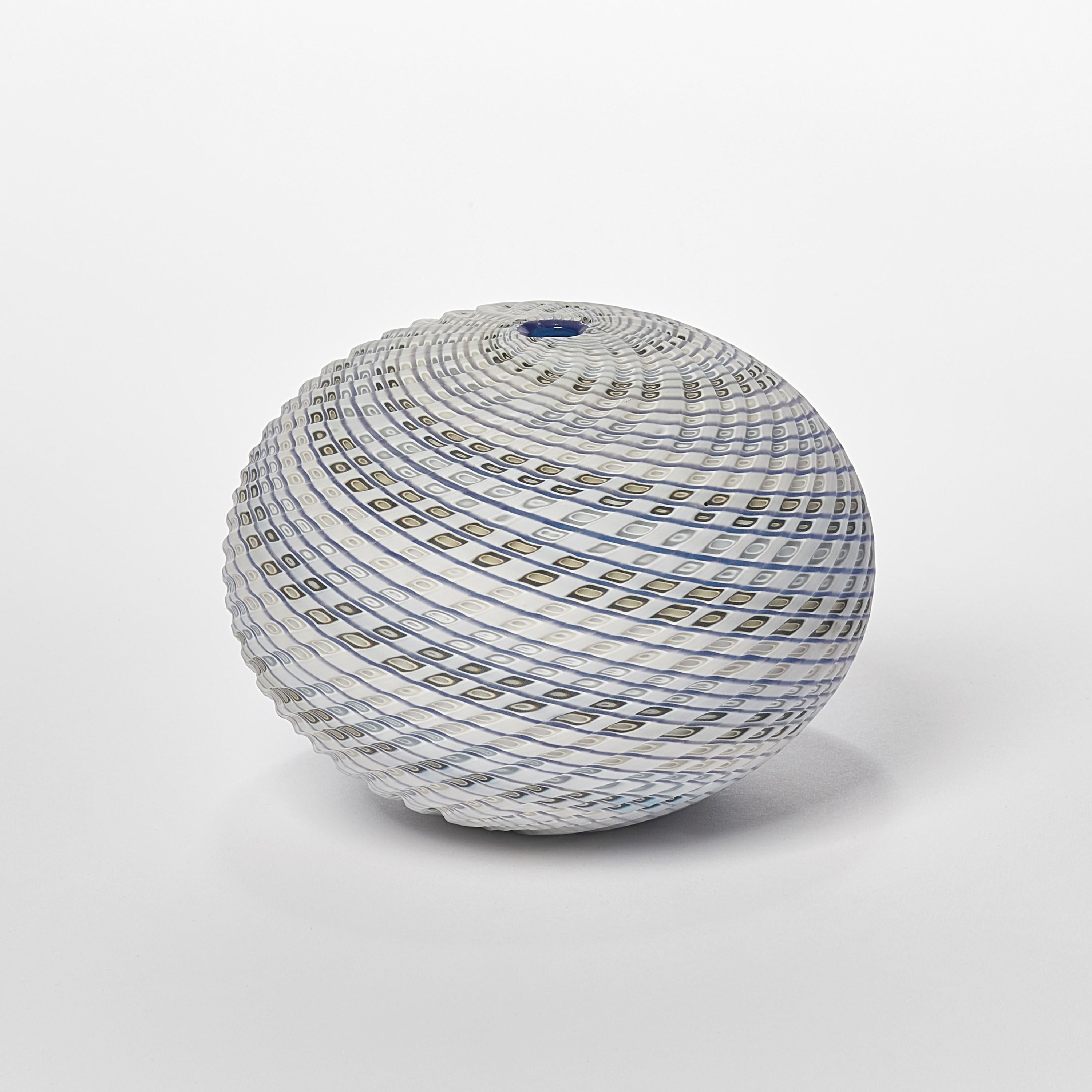 'Woven Three Tone Blue Round' is a unique handblown, sculpted and cut glass sculpture by the British artist, Layne Rowe.

Rowe’s inspiration is drawn from the dramatic Devon coastline which informs his love for detail, a constant theme for his
