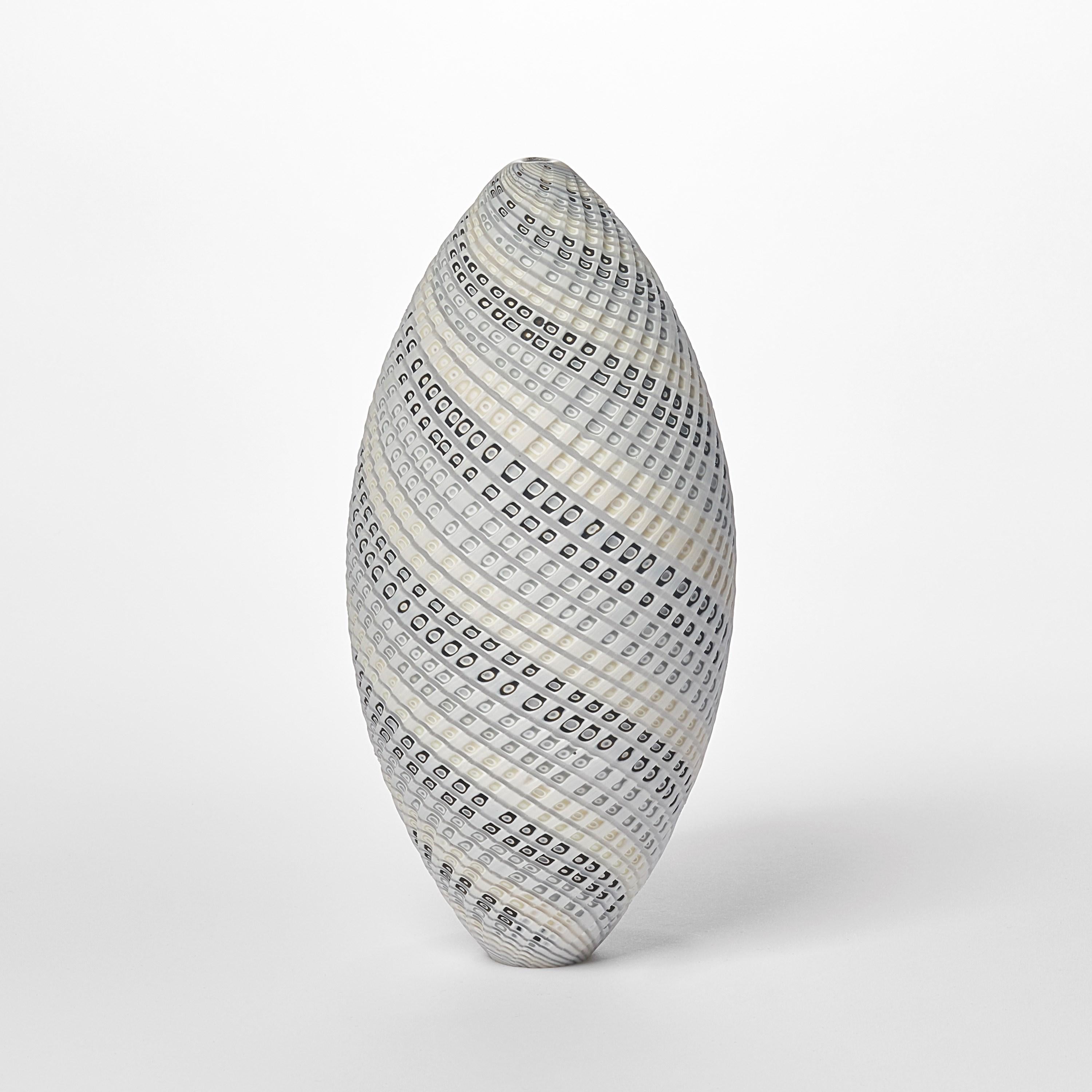 'Woven Two Tone Ovoid (med)' is a unique handblown, sculpted and cut glass sculpture by the British artist, Layne Rowe.

Rowe’s inspiration is drawn from the dramatic Devon coastline which informs his love for detail, a constant theme for his