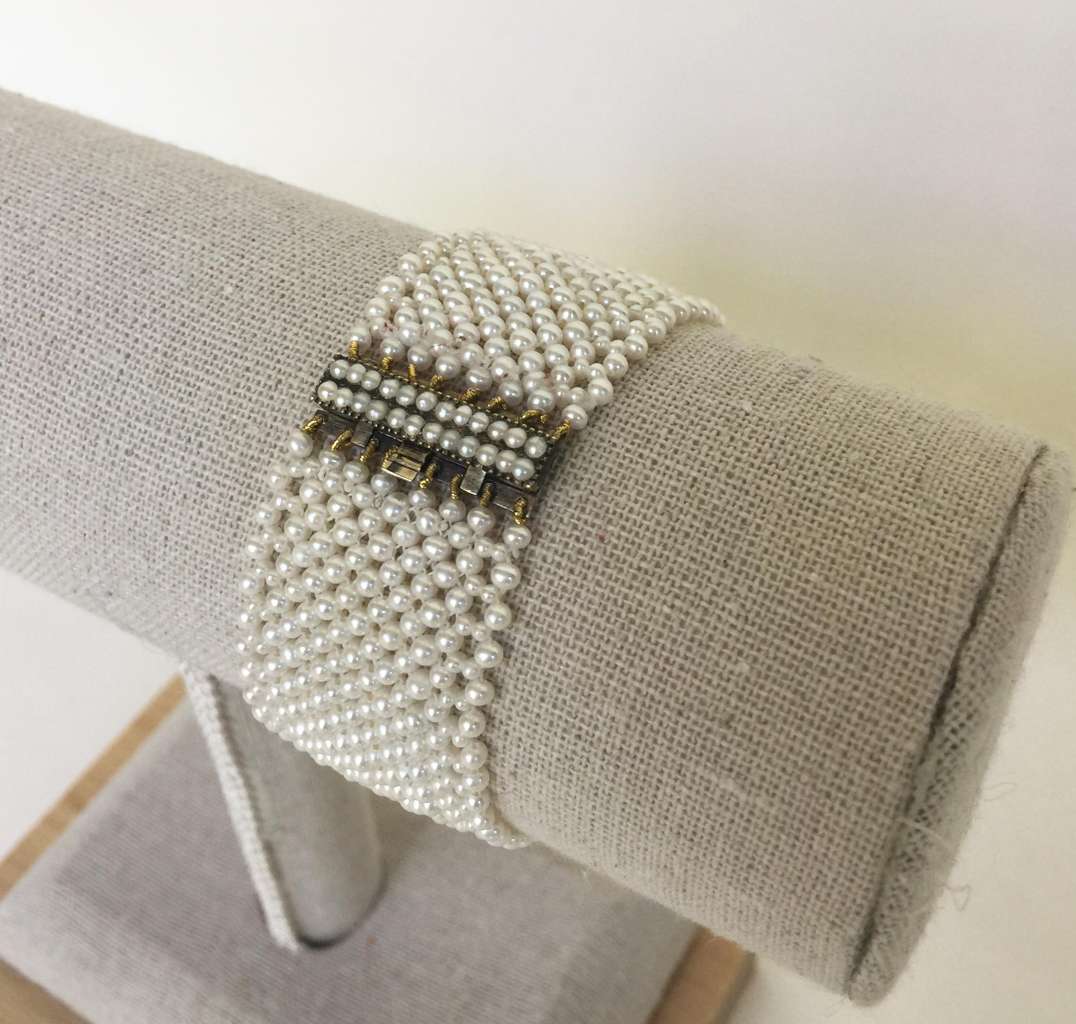 This woven white pearl bracelet with vintage clasp, original pearls, and 9k yellow gold is made with the finest pearls hand-selected by Marina J. The elegance of this bracelet is highlighted by the glowing white pearls intricately woven into a