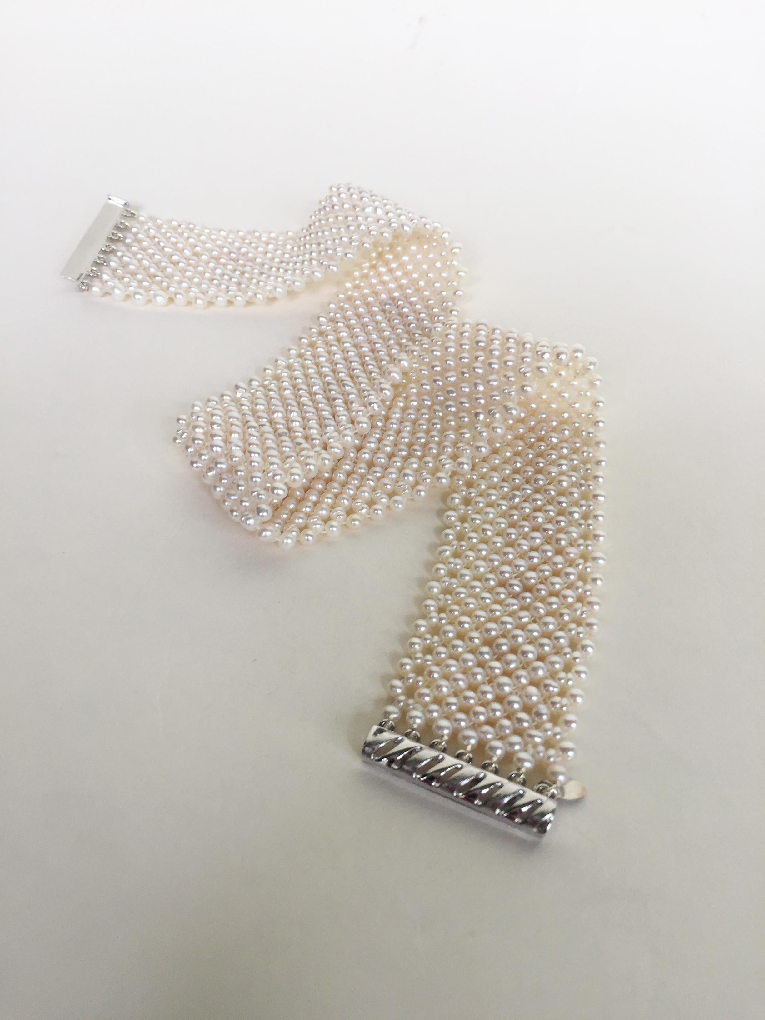 This woven white pearl choker with a rhodium-plated sterling silver sliding clasp is handwoven by Marina J. Each glowing white pearl (2.5-3mm) was handpicked to create an elegant and sophisticated lace-like design. This pearl choker is 1 inch wide