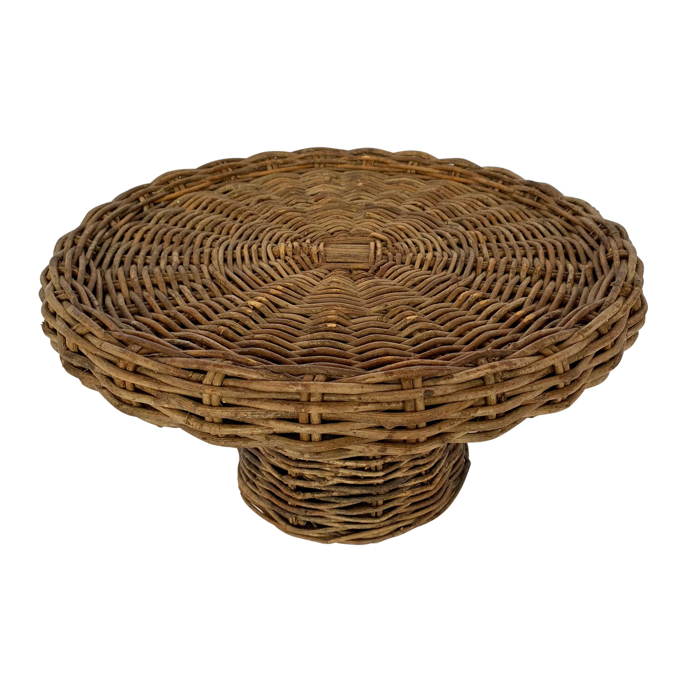 An American woven wicker cake stand perfect for displaying your masterful cake creations, perfectly plated pastries, or elevating your cheese plate to new heights.