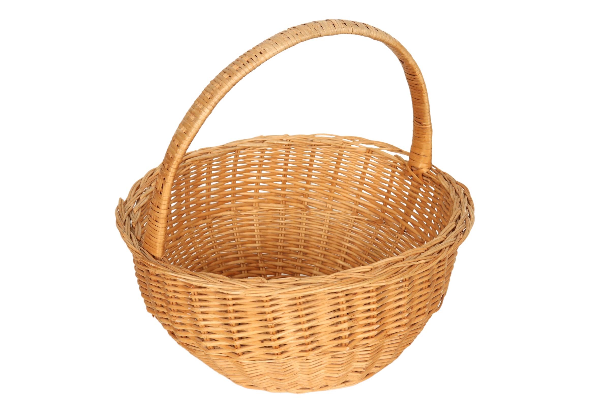 A traditional shopping or gathering basket made of wicker. An arched handle of bentwood bamboo is wrapped with rattan secured to the braided rim of the basket.
 