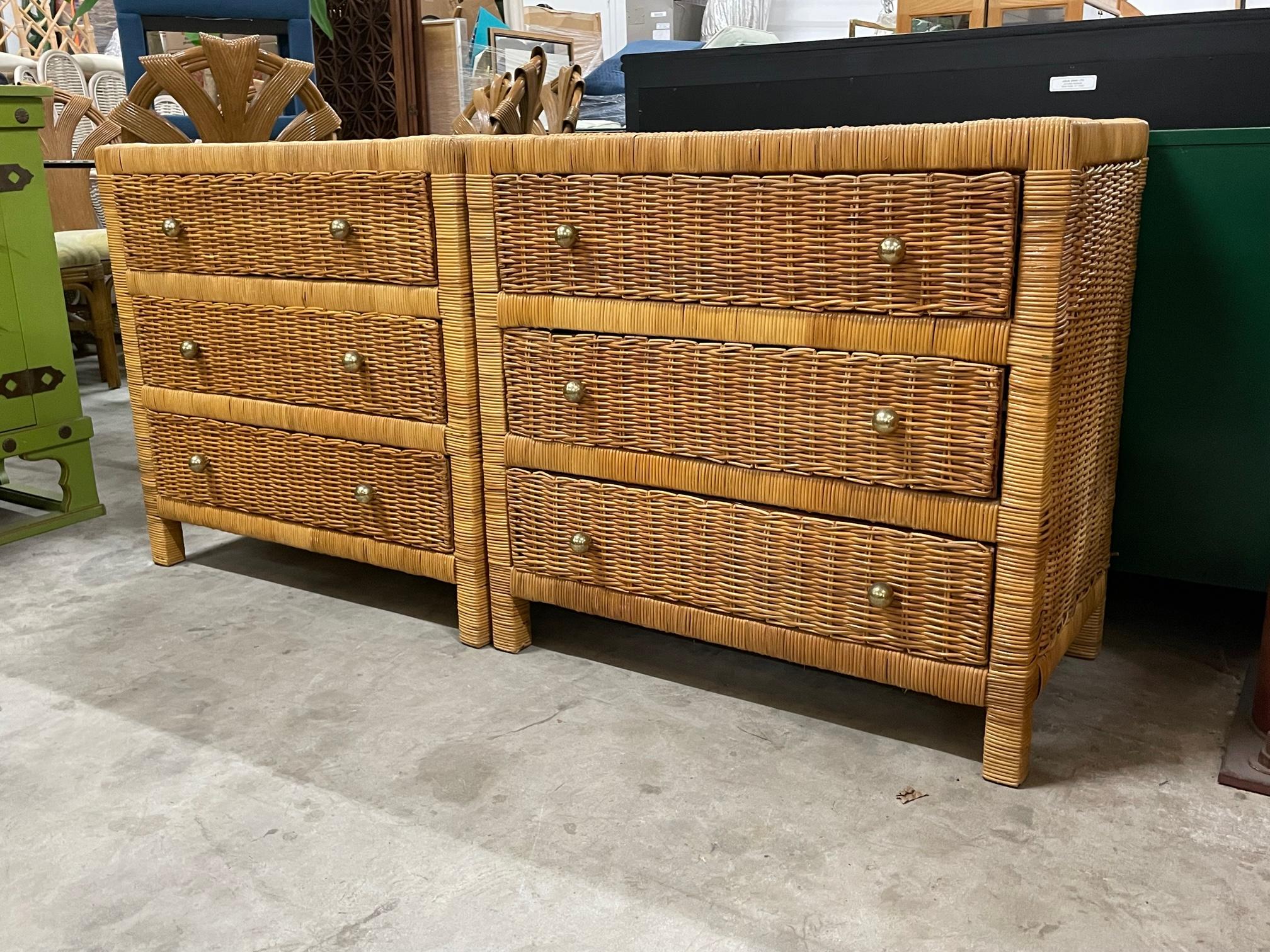 Pair of vintage triple dressers feature a full veneer of woven wicker over a wood frame and brass hardware. Could also be used as nightstands. Good vintage condition with minor imperfections consistent with age. May exhibit scuffs, marks, or wear,