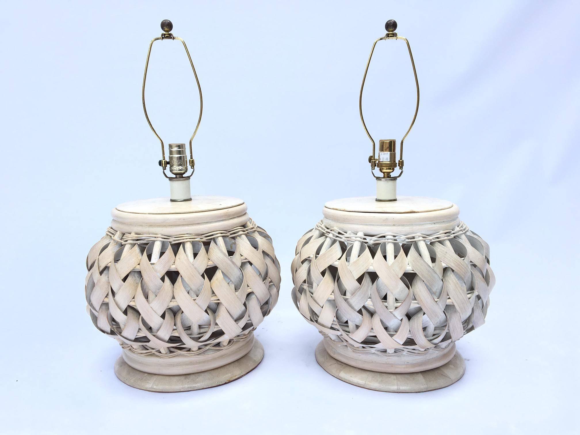 Pair of woven rattan lamps feature wide rattan woven into intricate braid patterns. Excellent vintage condition.
Lamps measure 25.5