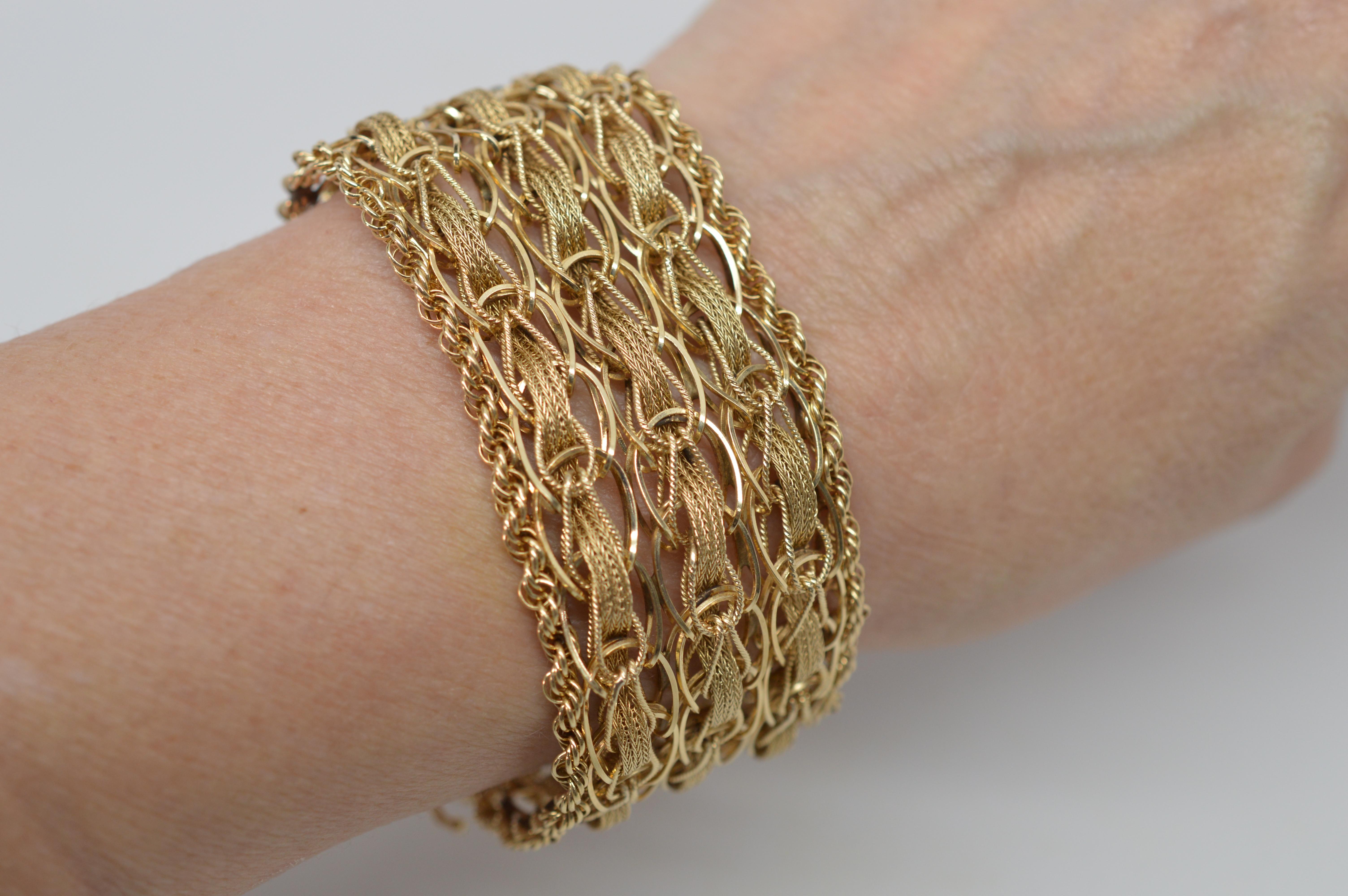 This will easily become your go to piece, made of plentiful lengths of 14 Karat Yellow Gold rope woven into a spectacular 1-1/4 inch wide bracelet with attractive texture and dimension. Circa 1960's and constructed with slide clasp and safety, this