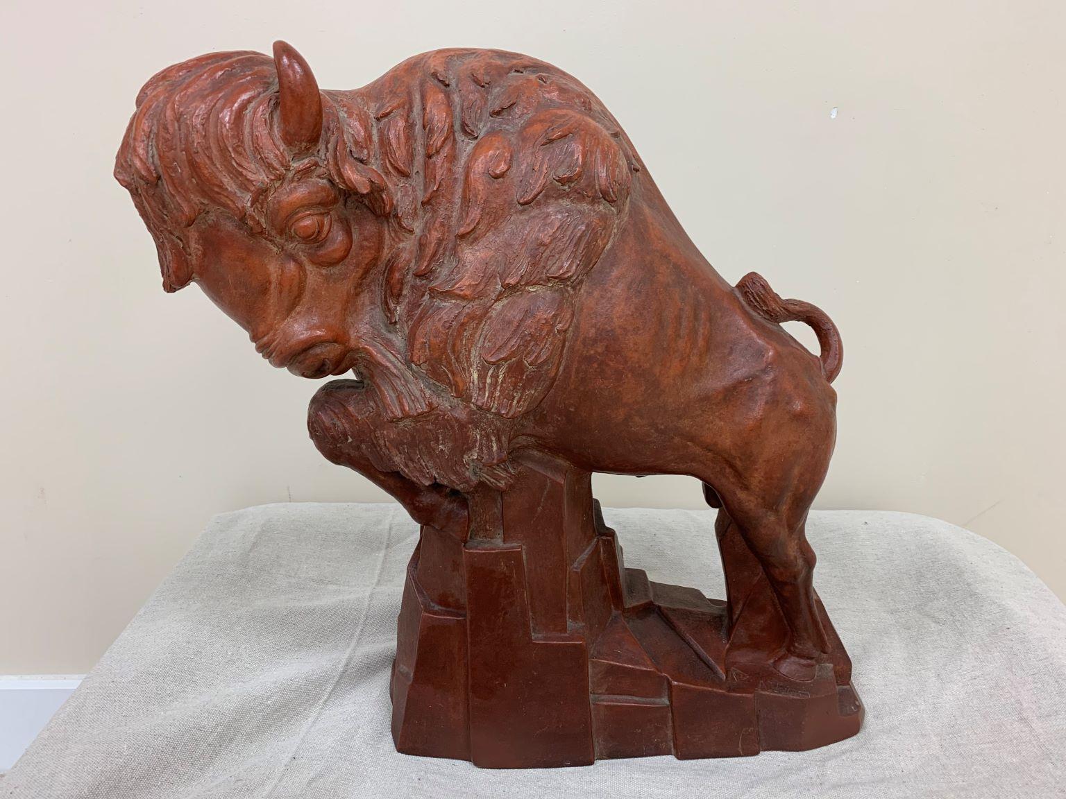 WPA terracotta buffalo sculpture by Anthony Vozech, circa 1930s. Dimensions: 8” wide 20” high 22” deep. Minor wear on the bottom edge.
Anthony Vozech was an Ohio artist that did WPA work in the 1930s and 1940s. One of his most famous works was an