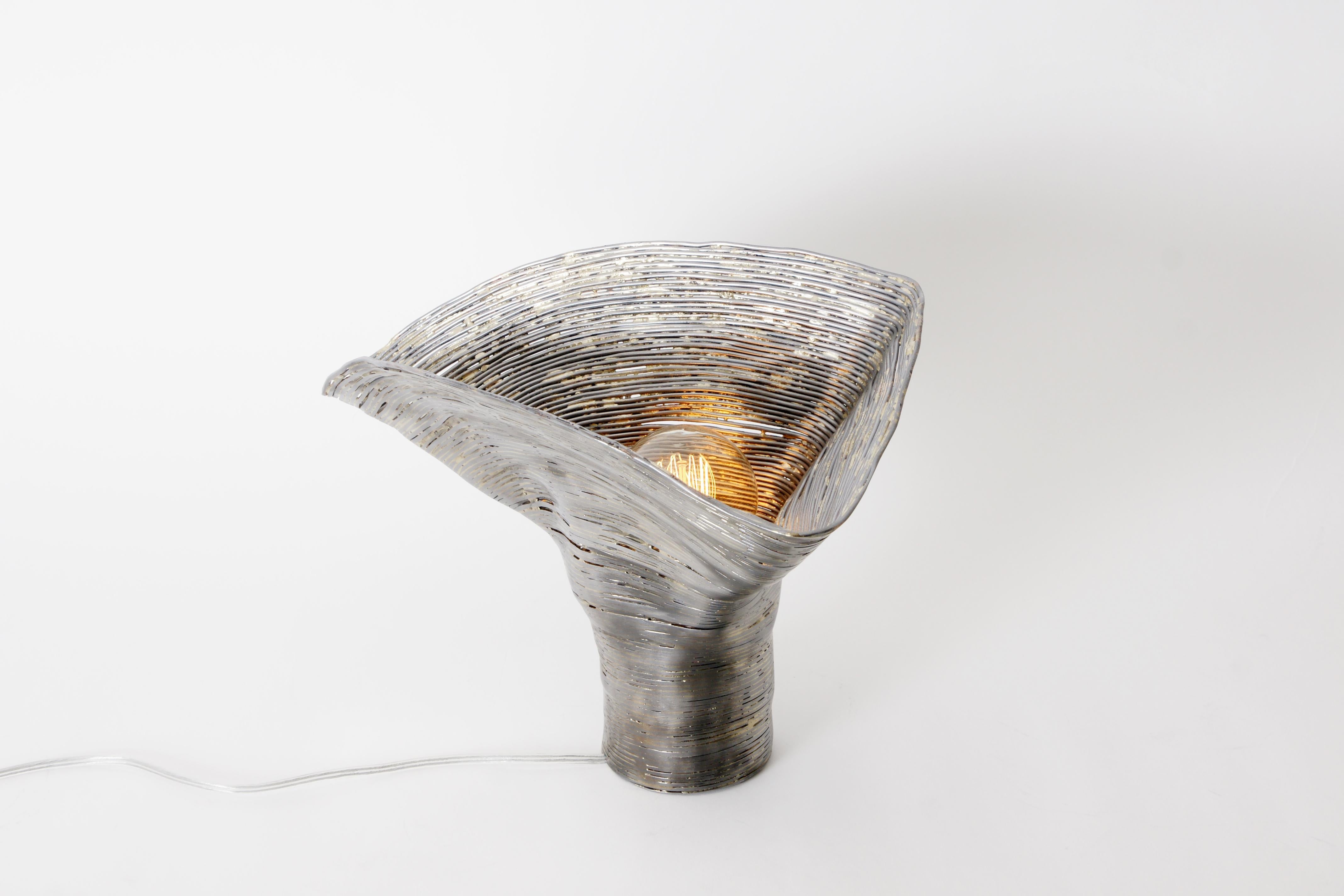 Wrap Alder table light by Johannes Hemann
Materials: Steel wire, brass
Dimensions: height 30cm, Ø 31cm

‘wrap, the series of objects by German designer Johannes Hemann examines the shells of things remaining after their disappearance. For this