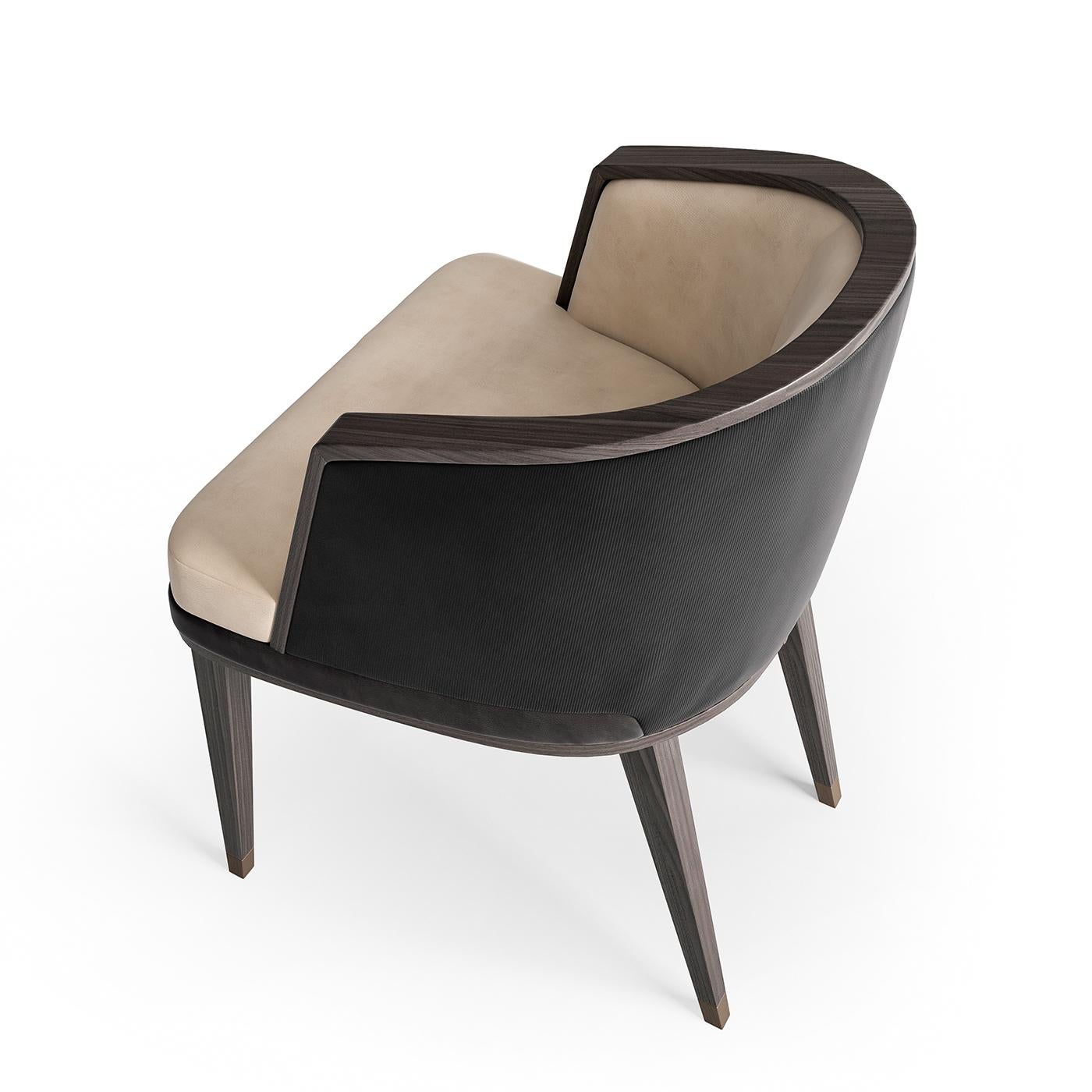 Envelop yourself in timeless chic style with the wrap around armchair. Featuring handsome veneer profiles, the chair back wraps around the base to become a cozy armrest, while the back and front can be upholstered in nabuck leather of different