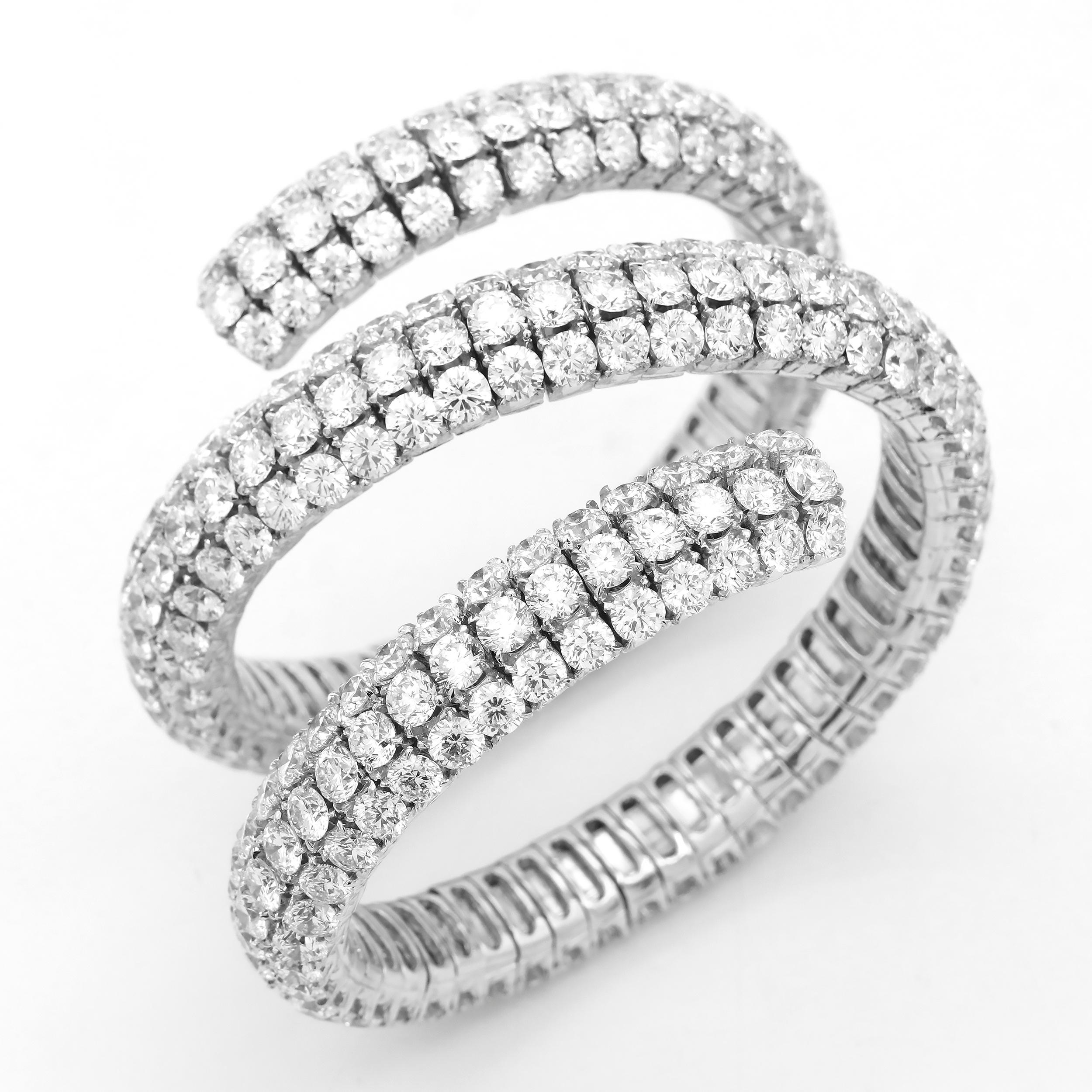 Wrap Around Flexible Bangle with 321 Round white diamonds and about 100 carats. Average color is GH and clarity is VS and Si. Heavy show stopper type of piece. Set in 18k White Gold. 