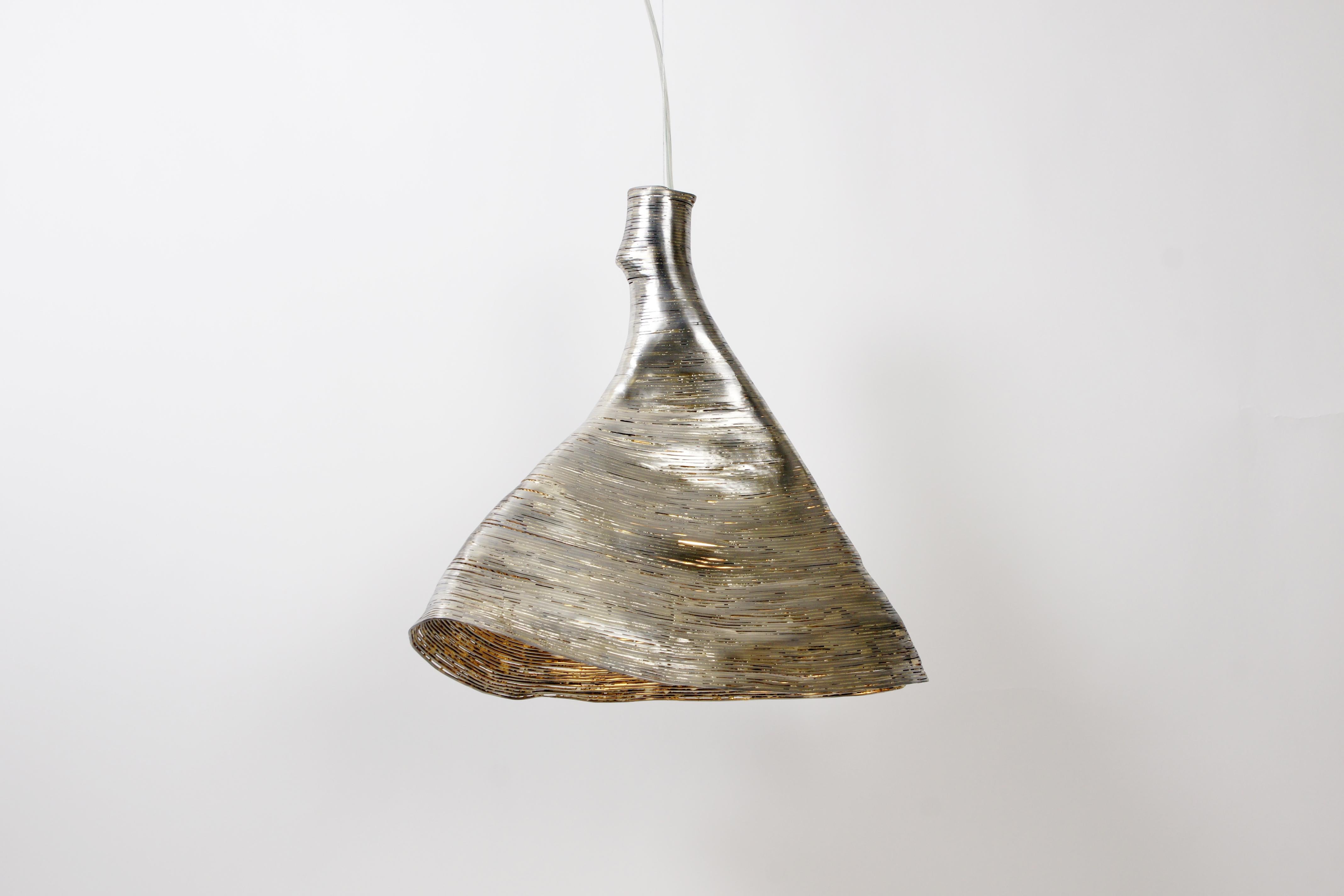 Wrap beech pendant light by Johannes Hemann
Materials: Brass and steel
Dimensions: height 45cm , Ø 38cm

‘wrap, the series of objects by german designer Johannes Hemann examines the shells of things remaining after their disappearance. For this