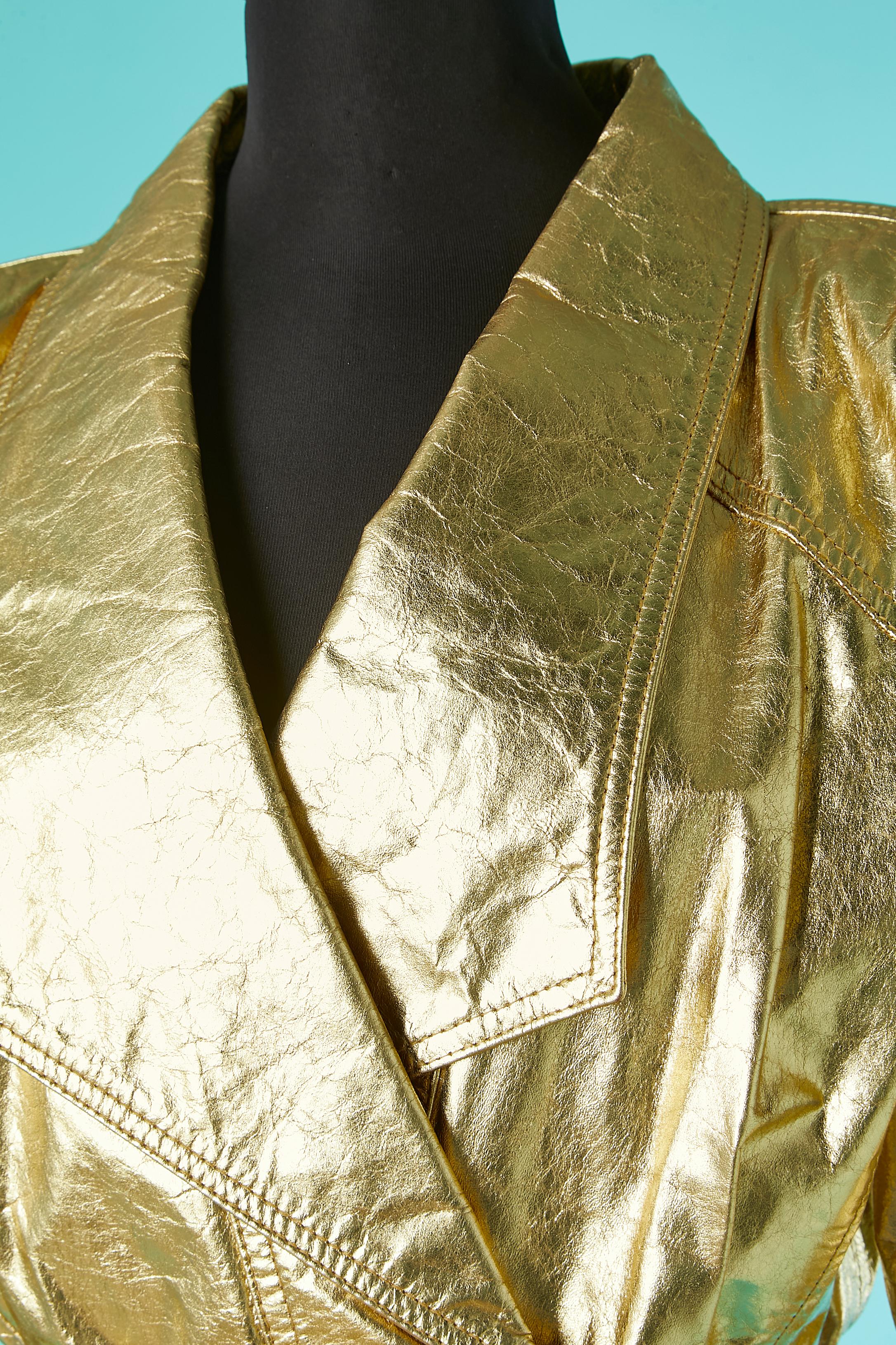 Wrap gold leather jacket with crinkle effect. No fabric tag composition but lining probably rayon. Raglan sleeves. Belt and belt-loop. Shoulder pad. 
SIZE L 