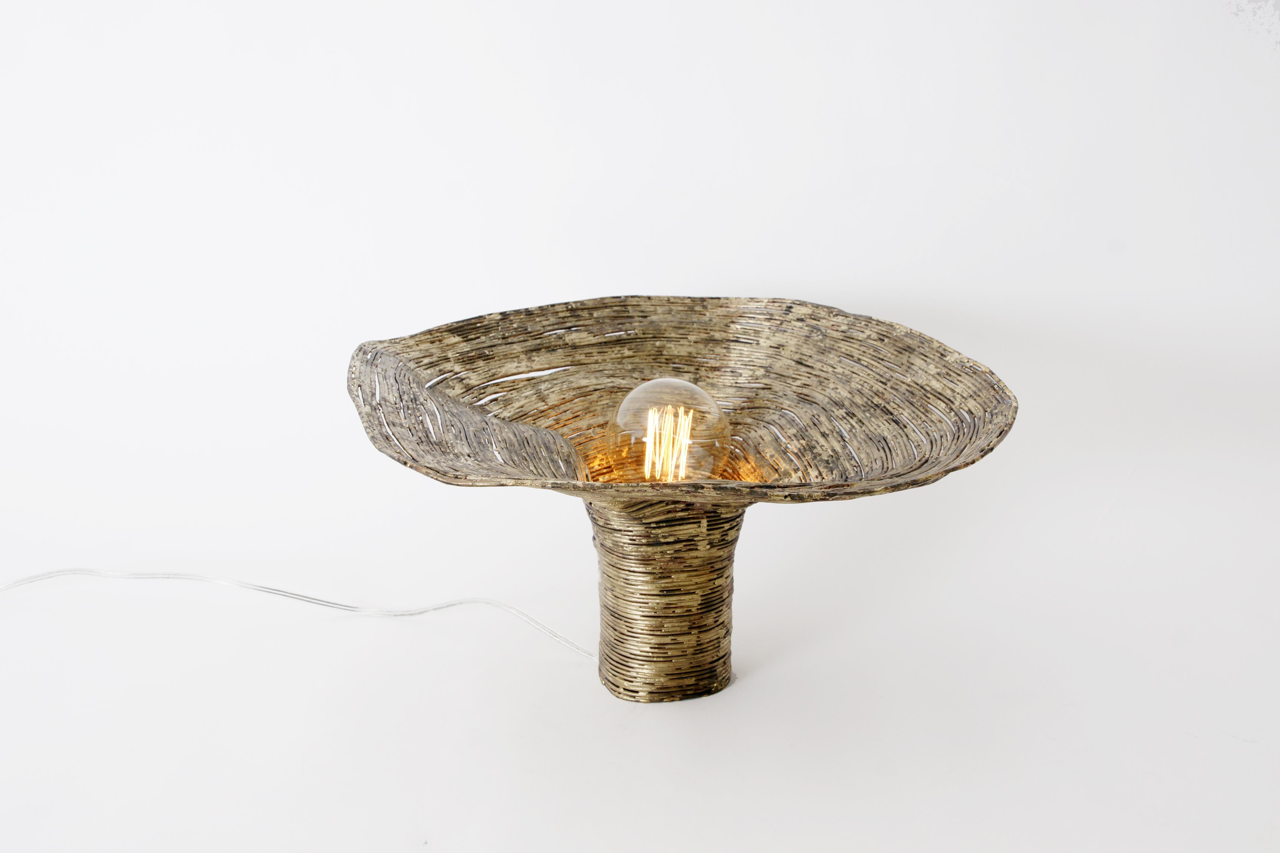 Wrap spruce table light by Johannes Hemann.
Materials: Steel wire, brass
Dimensions: height 27cm, Ø 42cm.

‘wrap, the series of objects by German designer Johannes Hemann examines the shells of things remaining after their disappearance. For