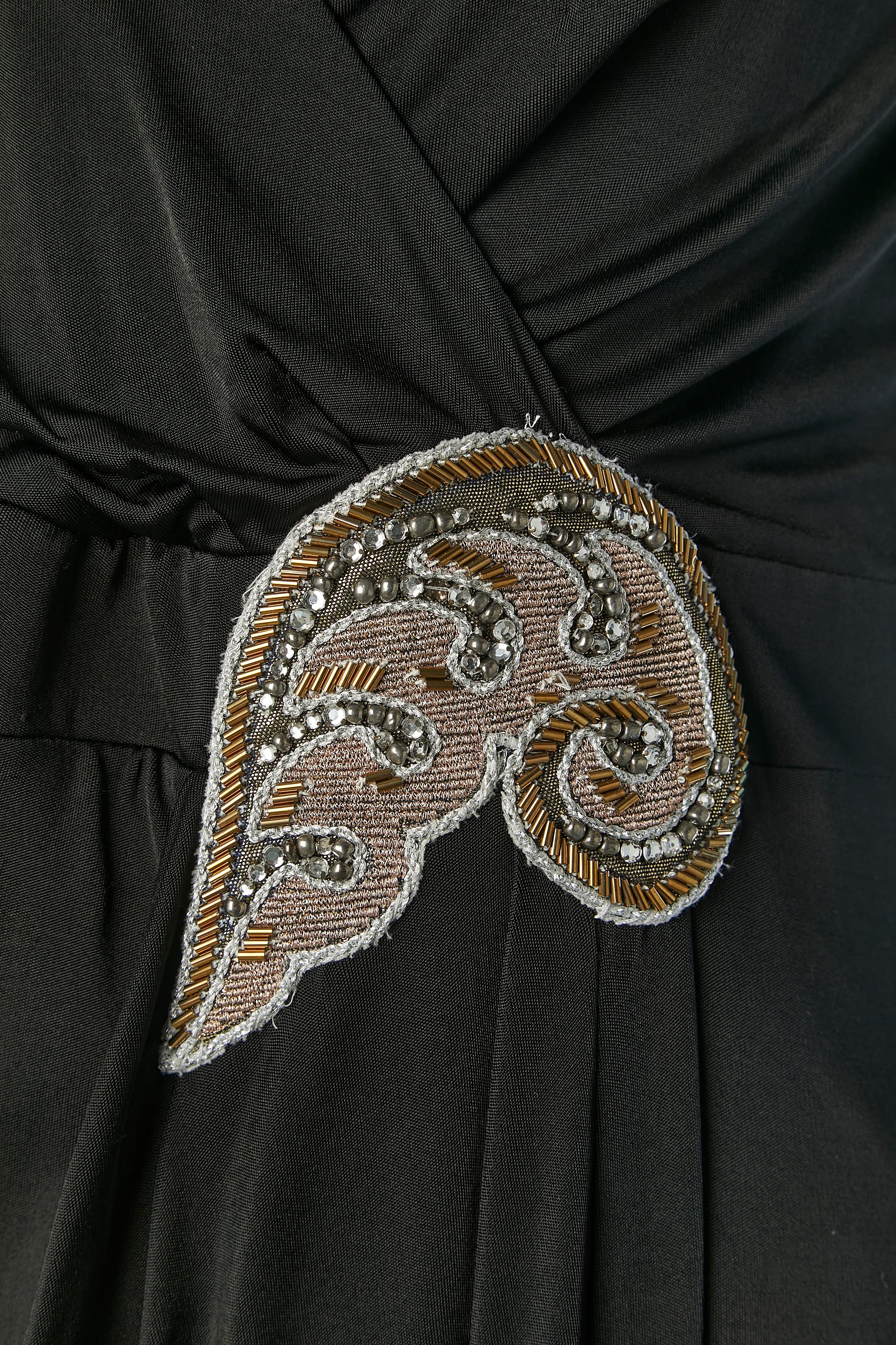 Black wrapped evening dress with rhinestone and beads embellishment. 
Main fabric composition: rayon. Polyester lining. Embellishement: rayon +beads+ lurex thread + rhinestone. 
Invisible zip closure on the left side.
SIZE 44 (It) 40 (Fr) M/L 
New