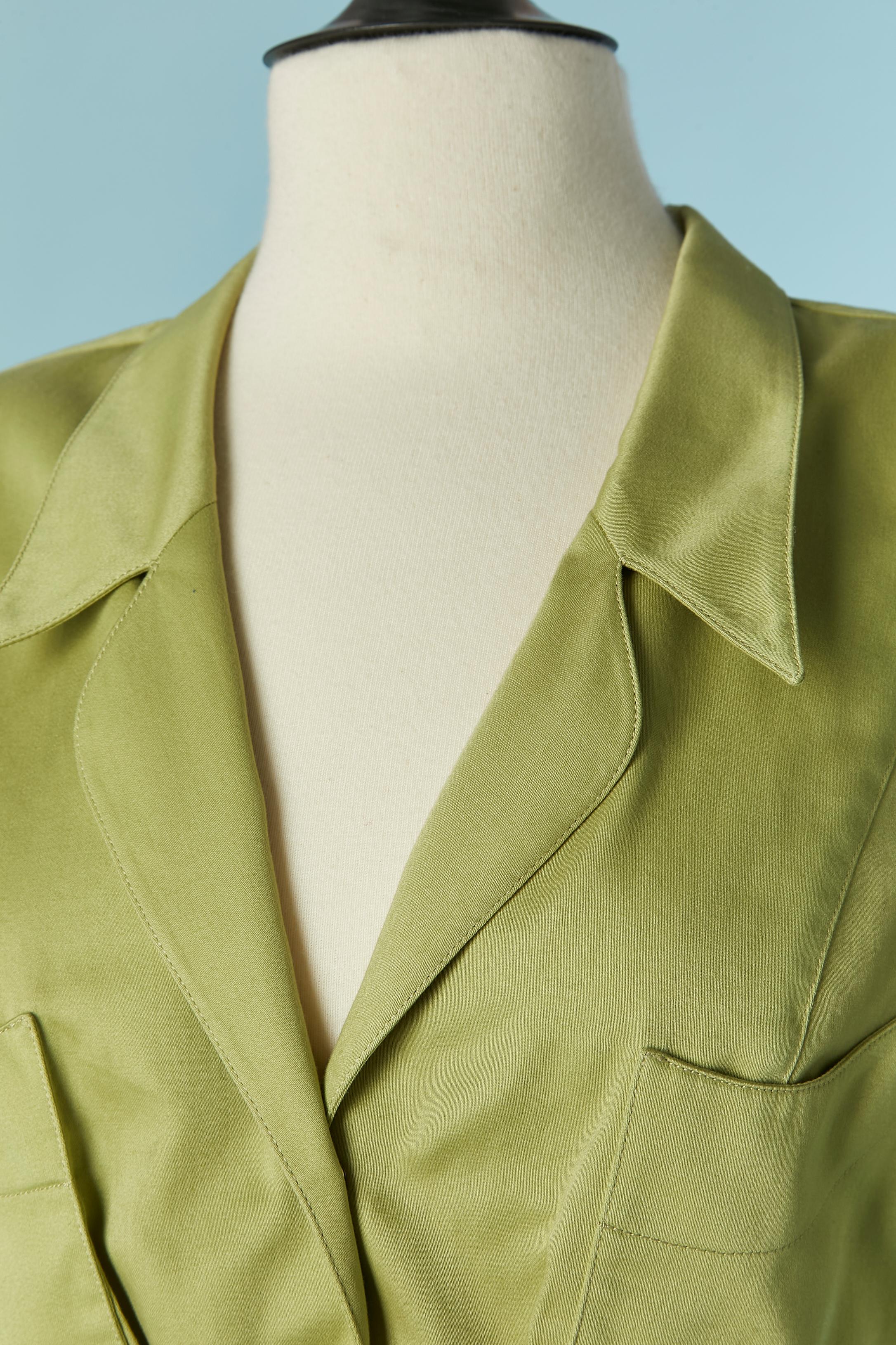 Wrapped  Green cotton dress  with snap closure on the middle front and fabric belt ( belt's lenght = 110cm) The fabric composition tag has been cut but the lining ( only inside the skirt part) is probably acetate or rayon.
Shoulder pad. Pocket on