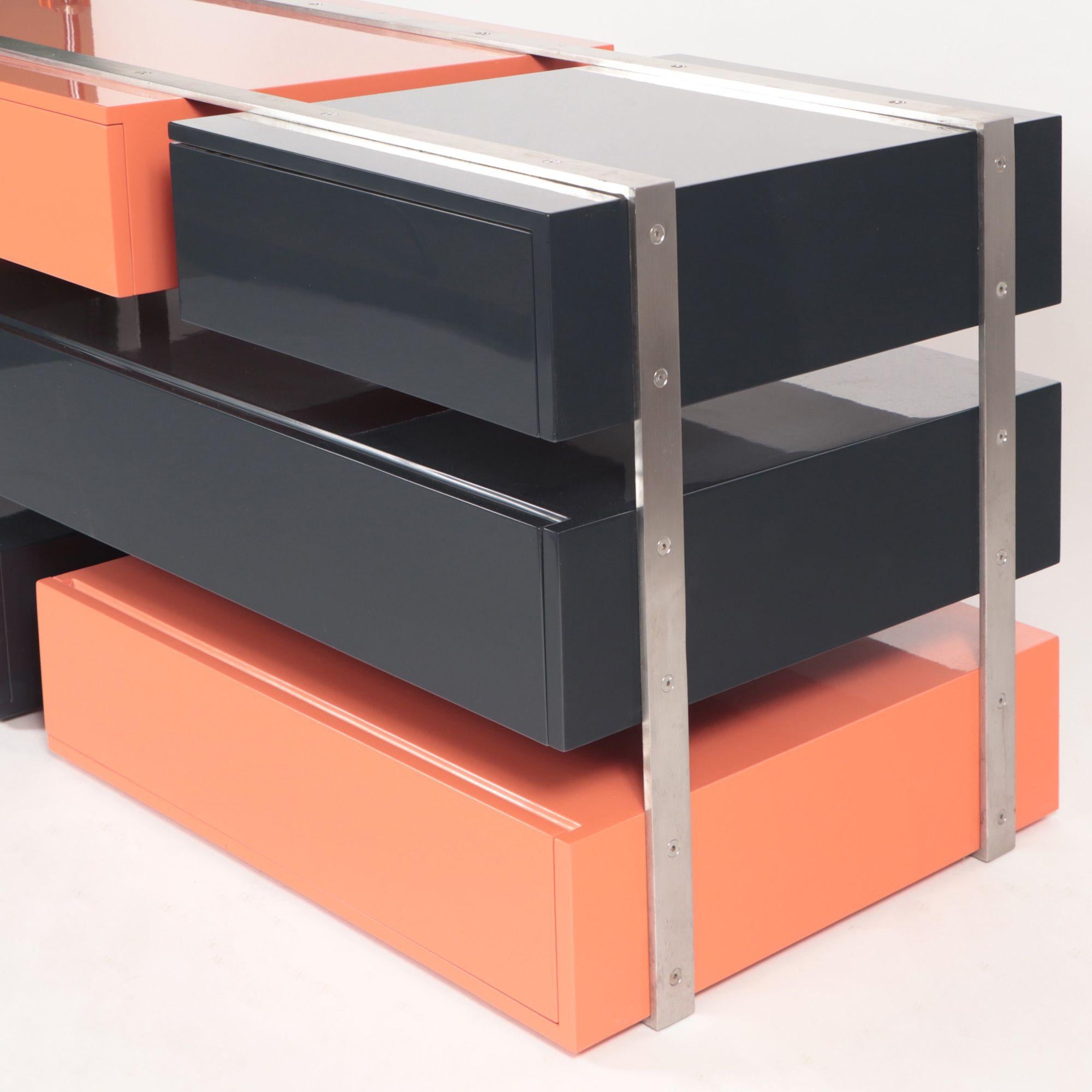 Designed by Maximilian Eicke for his brand Max ID NY.
 
This sculptural and functional dresser is made with high gloss lacquered drawers wrapped by solid brushed stainless steel 