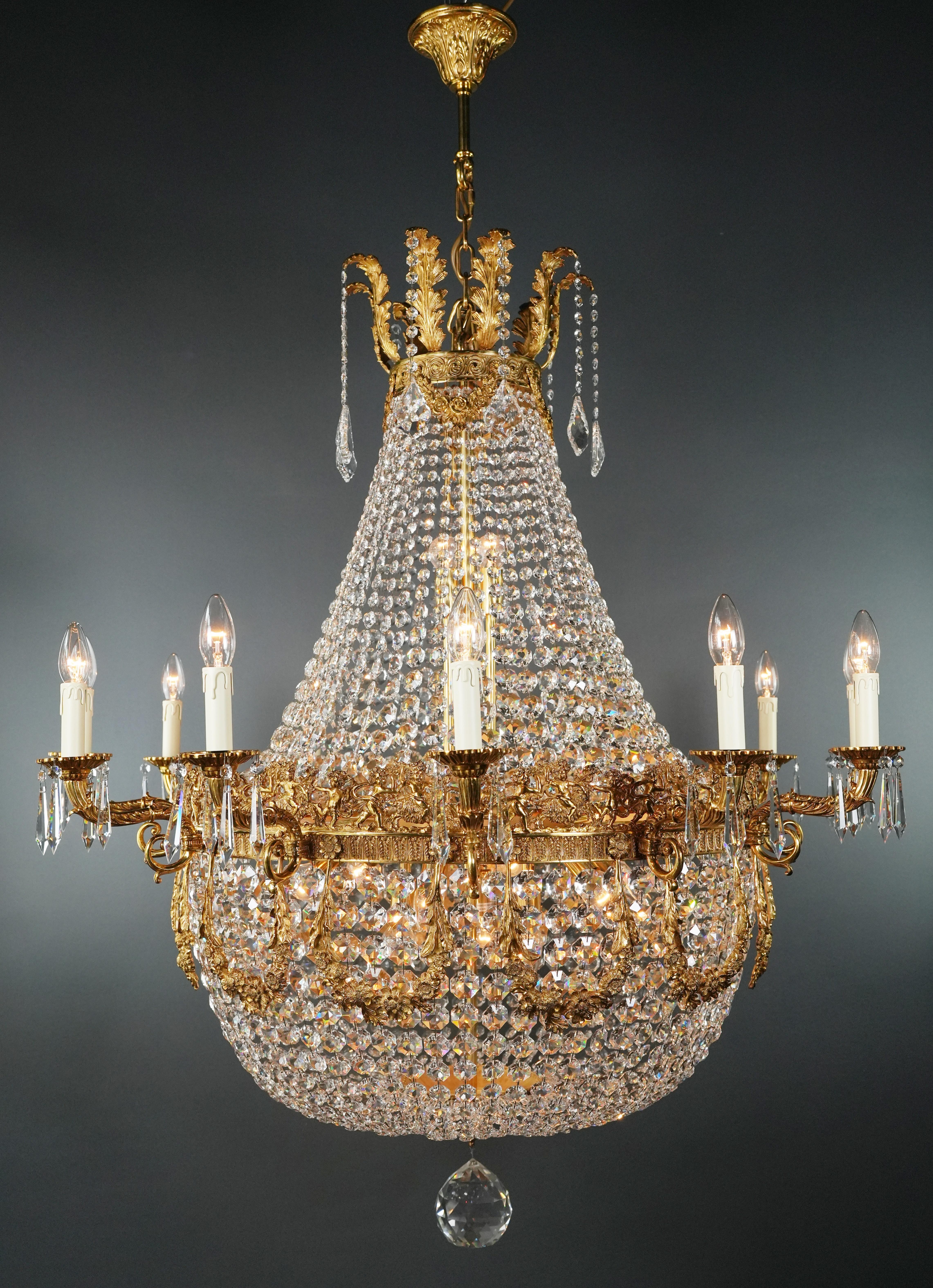 Introducing a stunning Brass Basket Empire Sac a Pearl Chandelier, an exquisite piece adorned with captivating crystals, reminiscent of the classical style of the Empire era. This is a new reproduction, and several are available, ensuring you can