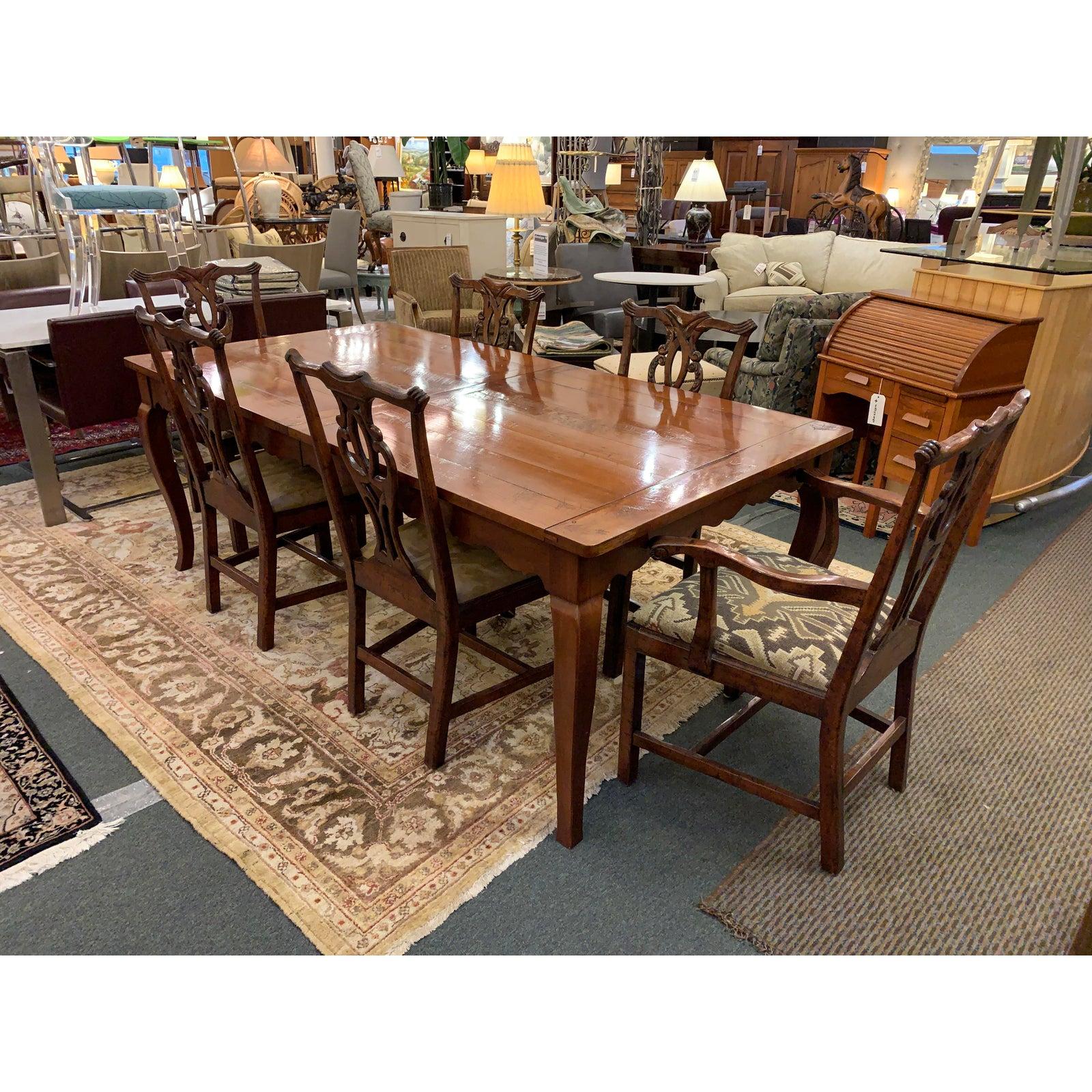 Presents a Wright Furniture Company extension table and Chippendale style chair dining set. Table is hand made in North Carolina with dovetail, mortise and tenon joinery. Sloped legs elegantly flow into scalloped apron underneath polished top.