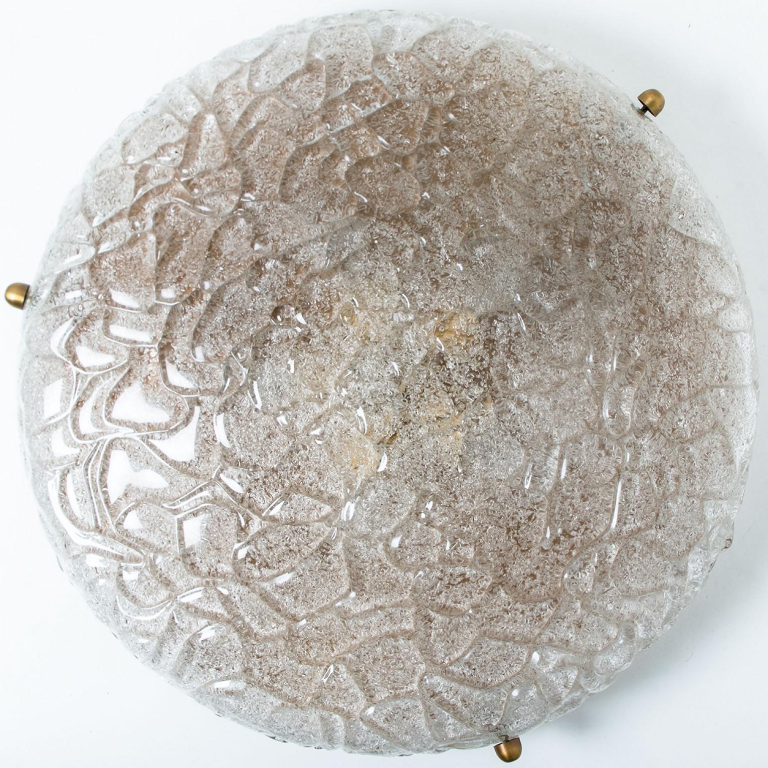 A high-end wrinkled glass flush mount by Hillebrand. Manufactured in the late 1960s-early 1970s. The brass ring holds a huge heavy blown glass with four brass brackets and brass backplate. The thick glass has a beautiful textured structure.