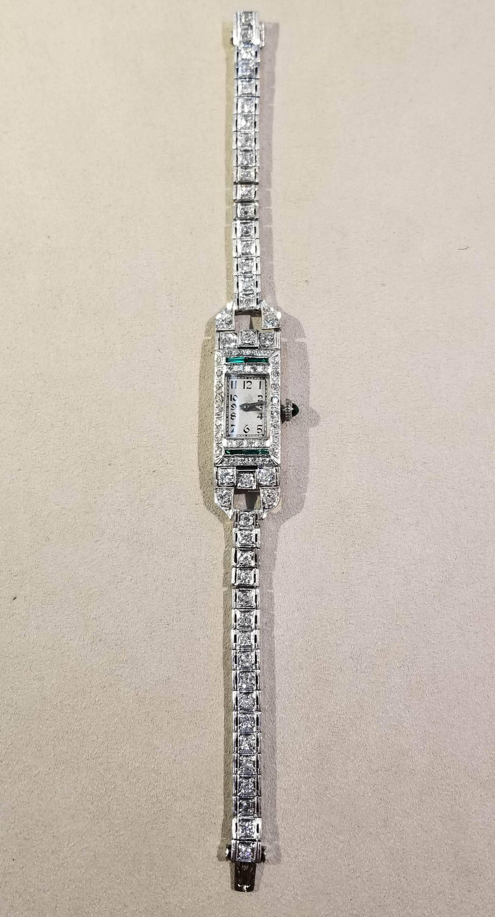 Wristwatch, Platinum, Diamond & Emerald, Art Deco, c.1920s.
Diamonds: 78 Old European Cut, HI in color, SI in clarity, weighing 3.20 cts.
Emerald: 1 Cabochon/Emerald Cut, 5 Baguette Cut, weighing .20 cts.