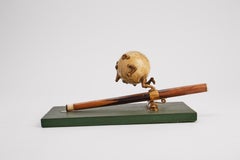 Writing clamp in the shape of a ball and a billiard cue, Great Britain 1890.