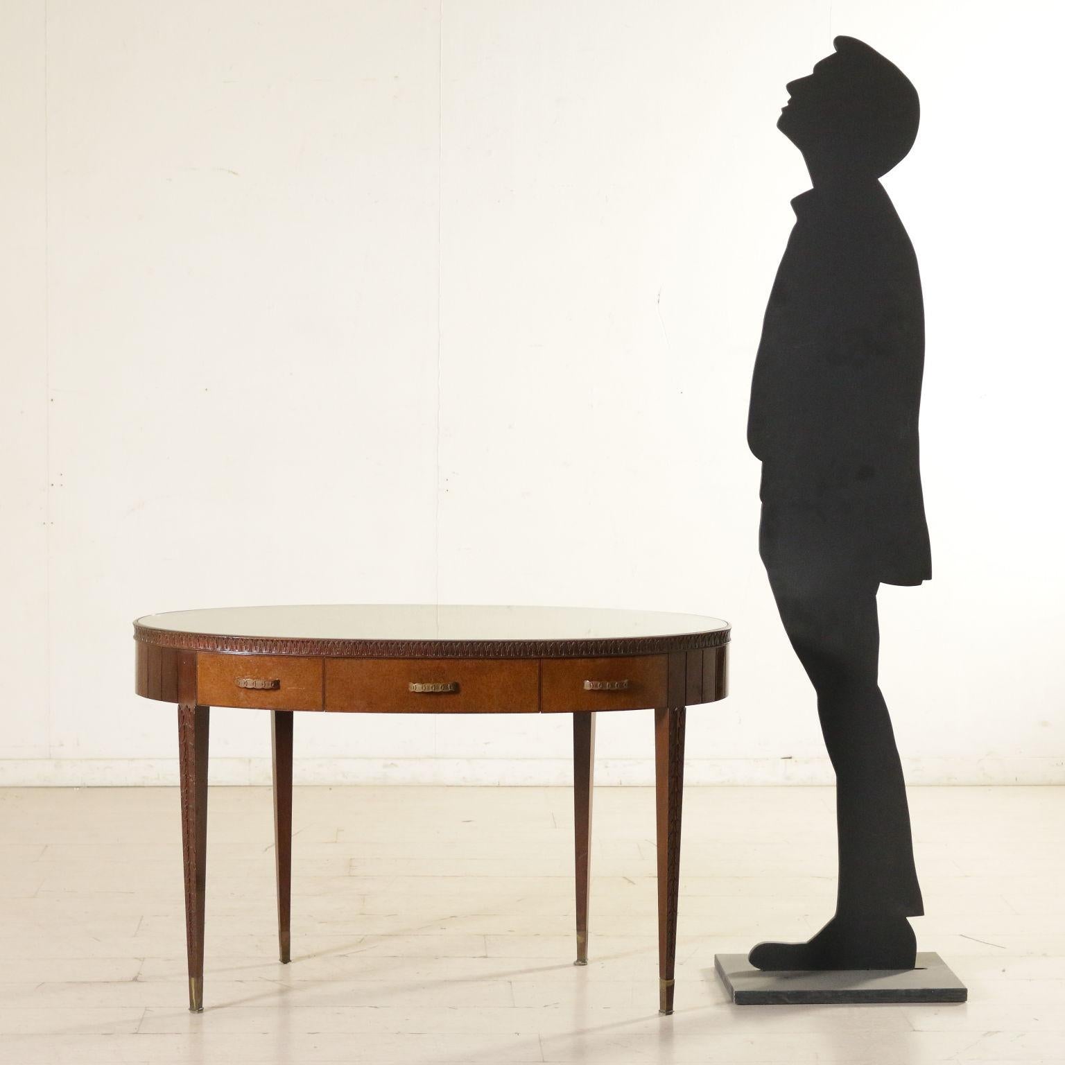 A writing desk attributable to Paolo Buffa (1903-1970), mahogany and brier veneer, carved ornaments, brass handles and ferrules, transparent glass on the top. Manufactured in Italy, 1950s-1960s.