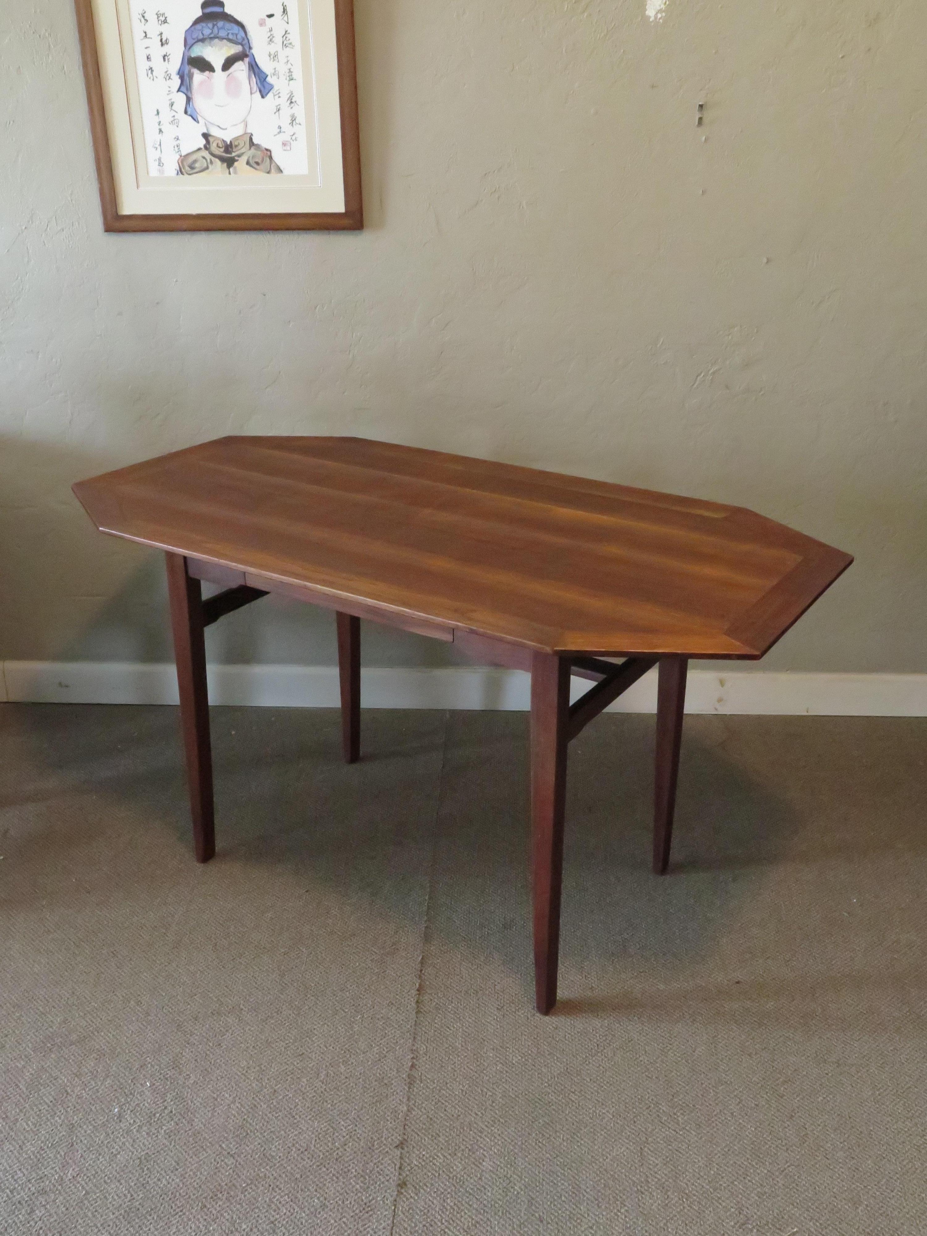 Beautiful and rare walnut desk designed by Edward Wormley, manufactured by Dunbar ca' 1950's. Single drawer, dark walnut original finish, with nice graining. Edges are raised to give it a floating effect.