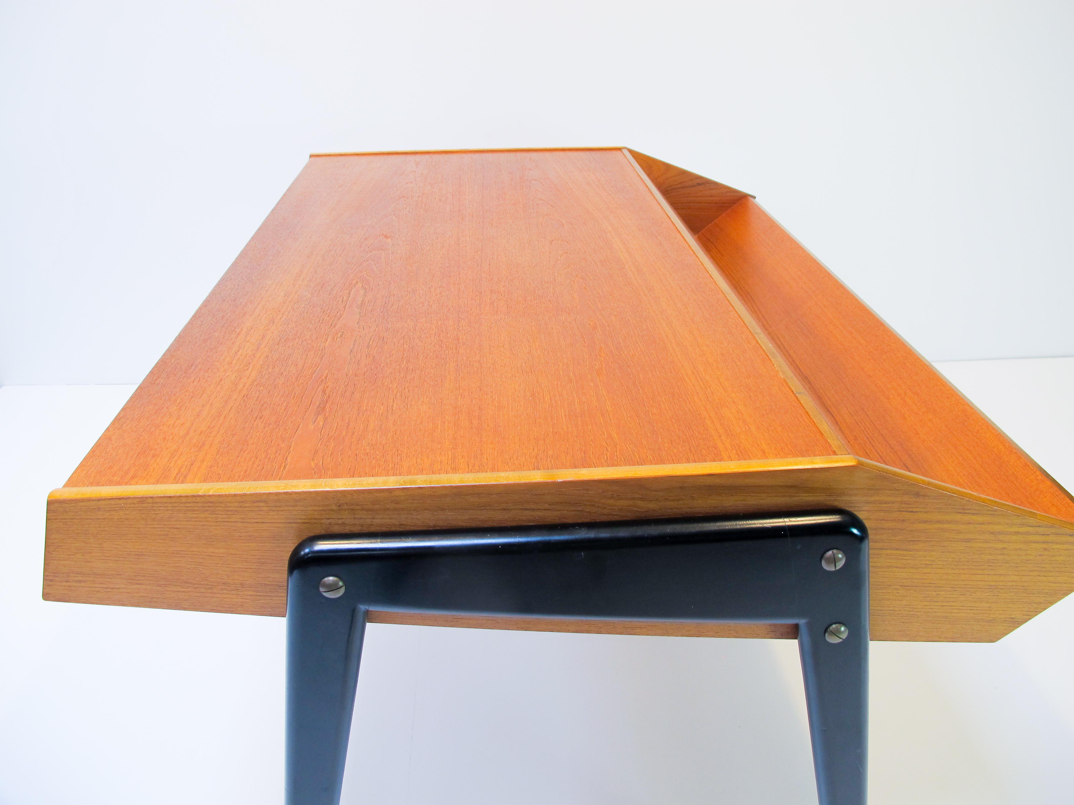 Writing desk designed by Bengt Ruda, 1950s . 
The material are teak and lacquered beech. Theres to drawers and they are fully length with the depth of the desk. 

Its possible to separat the legs from the desk part.