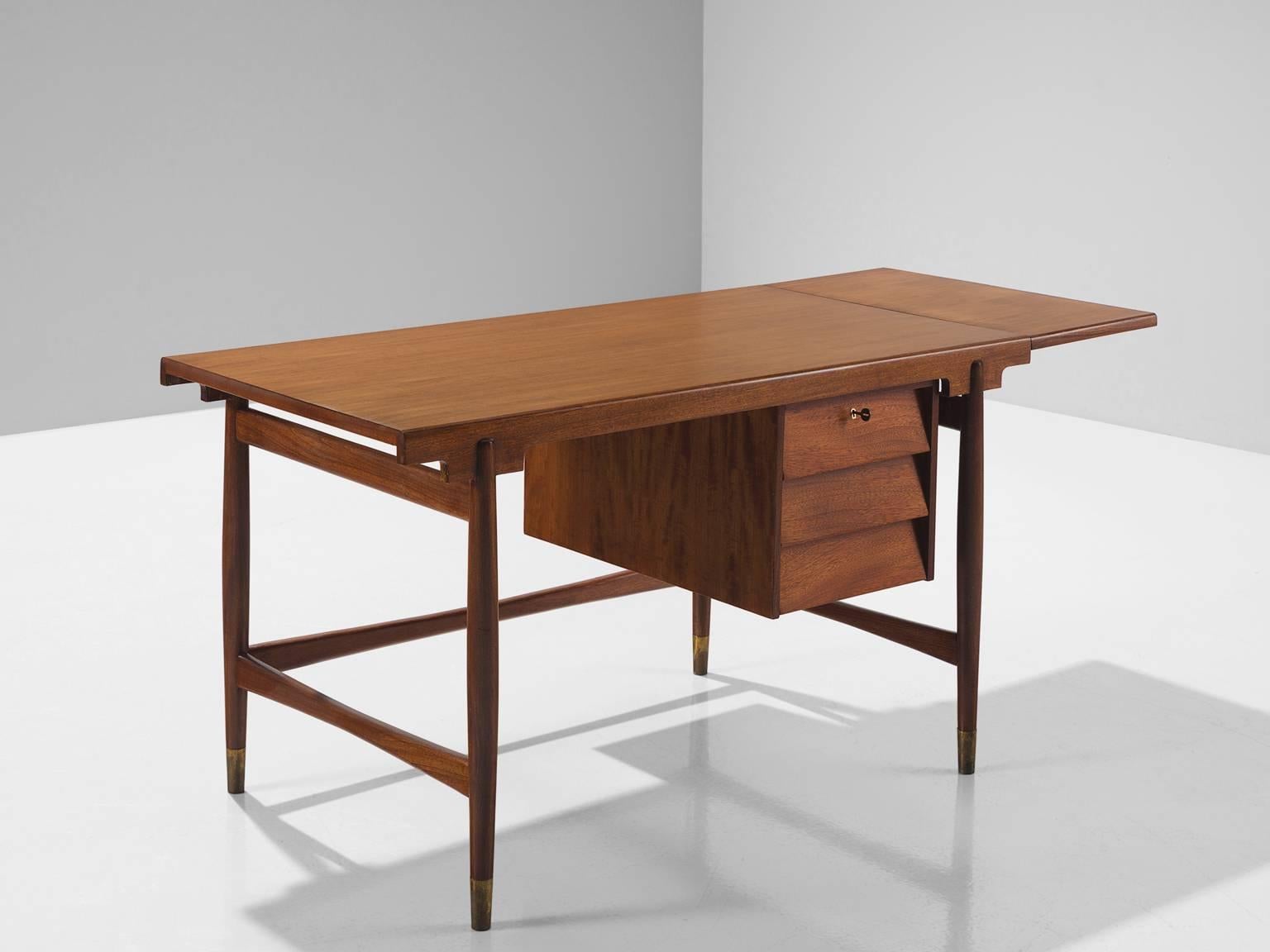 Desk or writing table, teak and brass, Scandinavia, 1950s

This sculptural freestanding desk is executed in teak and sled bases and contains one section with three drawers on the right sides which can be locked with a brass key that is included.