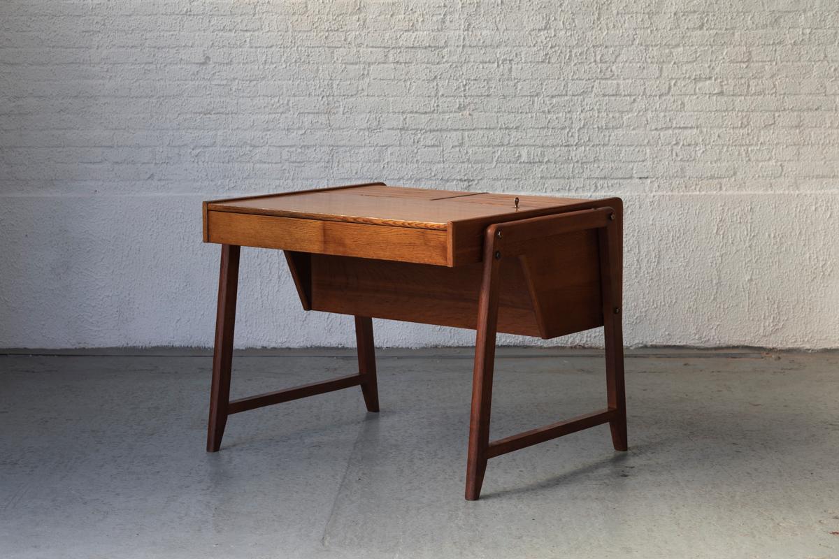 Freestanding writing desk designed by Clausen & Maerus for Eden Rotterdam, Nordic design produced in the Netherlands in the 1960’s. This executive desk in solid teak and teak veneer features two drawers and three roll top cabinets which are