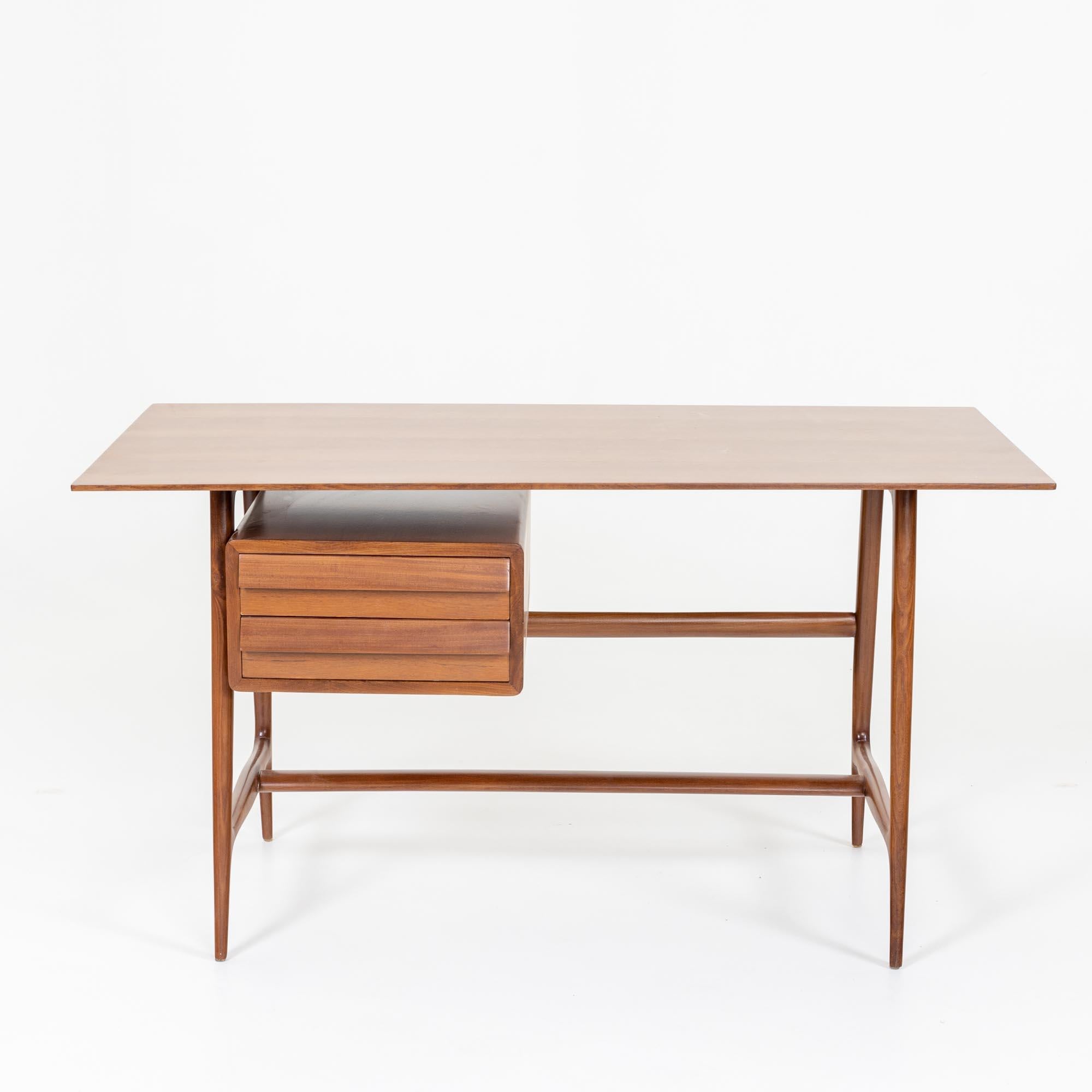 Small desk with two drawers on the sides and rectangular veneered table top. The desk stands on an elegant frame of smooth polished wood with conical legs. The desk has been restored and polished by hand.