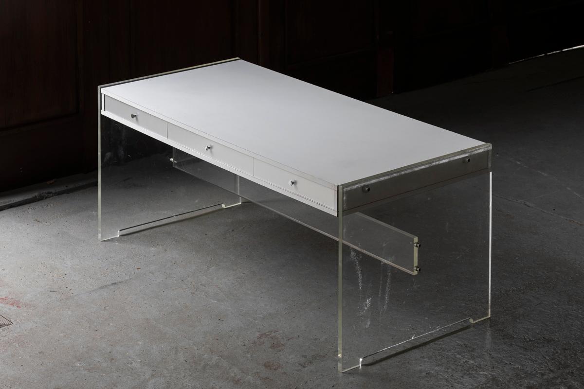 Writing desk designed by Poul Norreklit and produced by Sigurd Hansen Mobelfabrik in Denmark around 1968. The sleek drawers and plexi sides give this piece an airy look. The top is in white laminate, the drawers are finished with aluminum, the feet