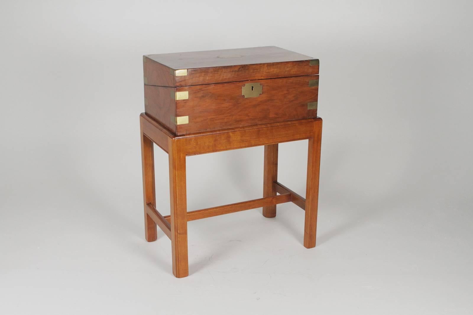 Writing desk on Stand stamped R E Johnson on base> The boxed lap desk with brass mounts opens to reveal a tooled leather surface with compartments for pens and indwells. The Stand in a Classic Chinese Chippendale style. Measures: 17 W x 10.5 D x
