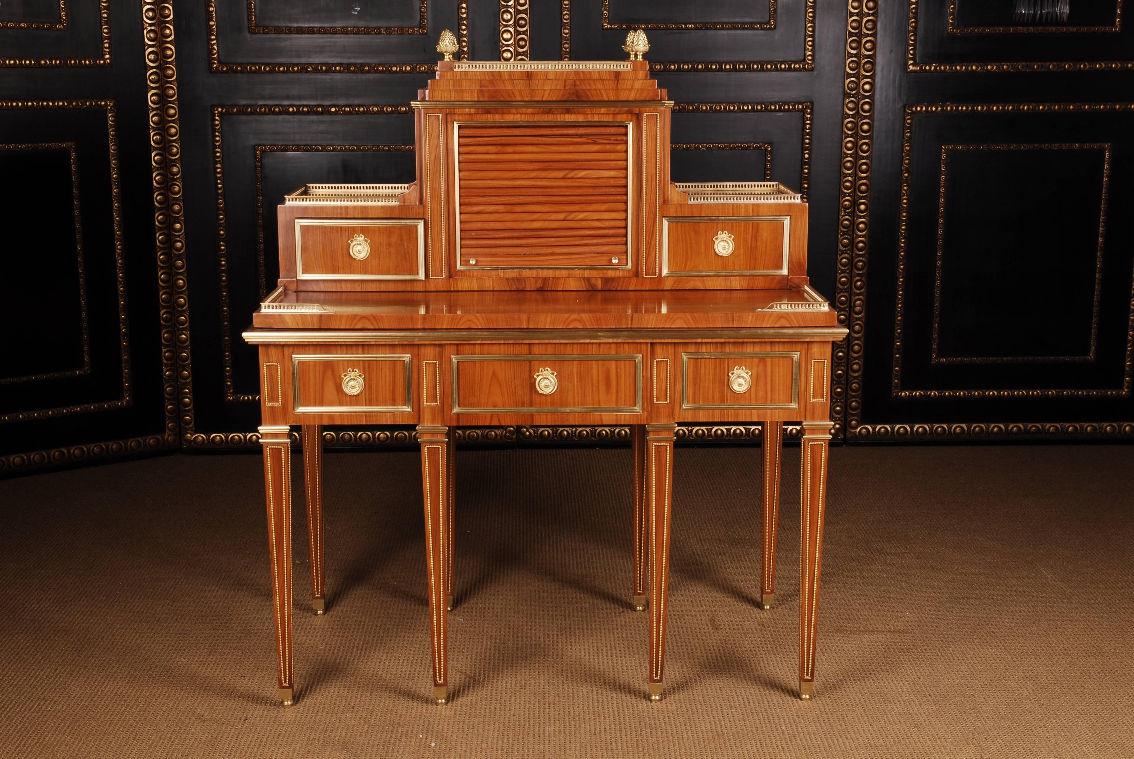 Palisander on solid pinewood. Border table on the front side one real and two false drawers, on the side a secret drawer over conical pointed, with brass beaded legs. The
drawer fronts in brass profile. A flush edging gallery in balustrade form. A