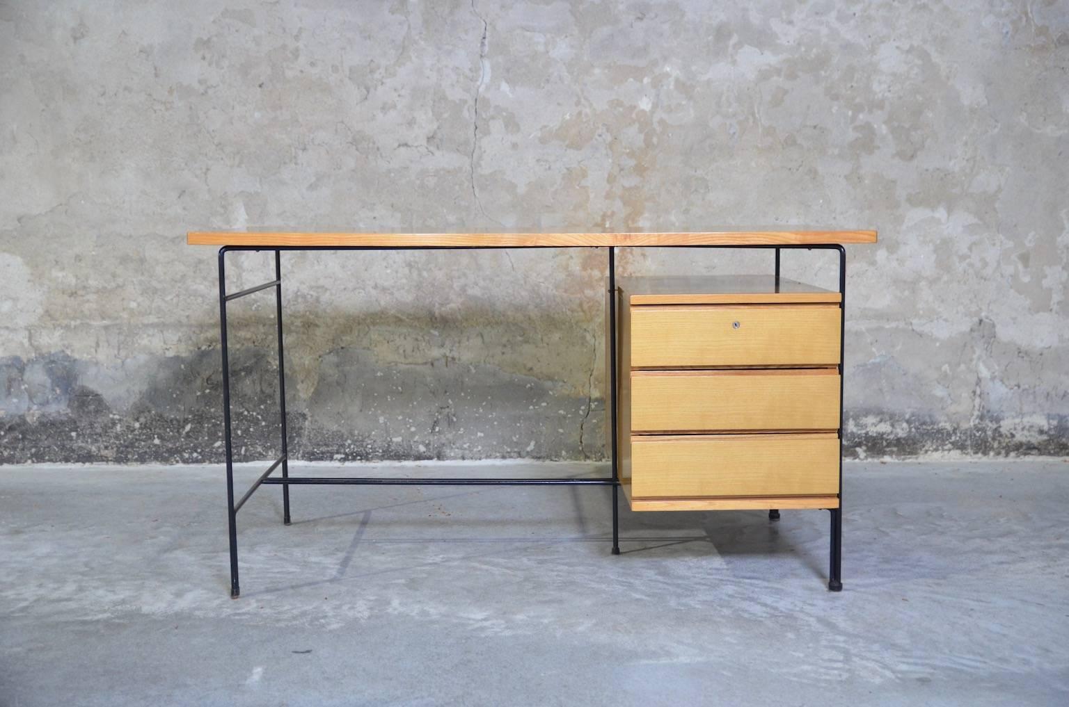 Writing desk with an ash tabletop and three drawers on a black lacquered metal base. The inside measurements of the drawers: height 12, width 35.5, depth 58 cm. The key is not available anymore.