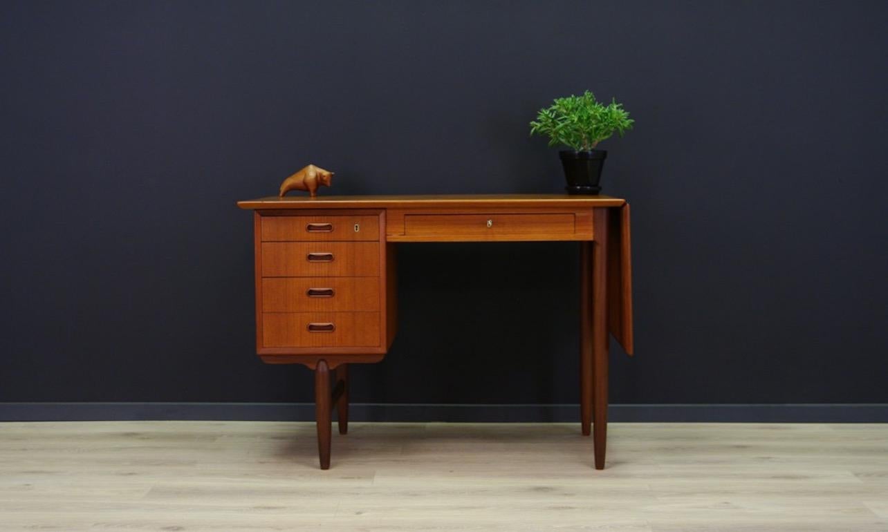 Original 1960-1970 desk - minimalistic Danish design, perfect in every detail. A desk veneered with teak. The front has five capacious drawers, bookshelf at the back. An additional advantage is the extandable tabletop. It has a key. Preserved in