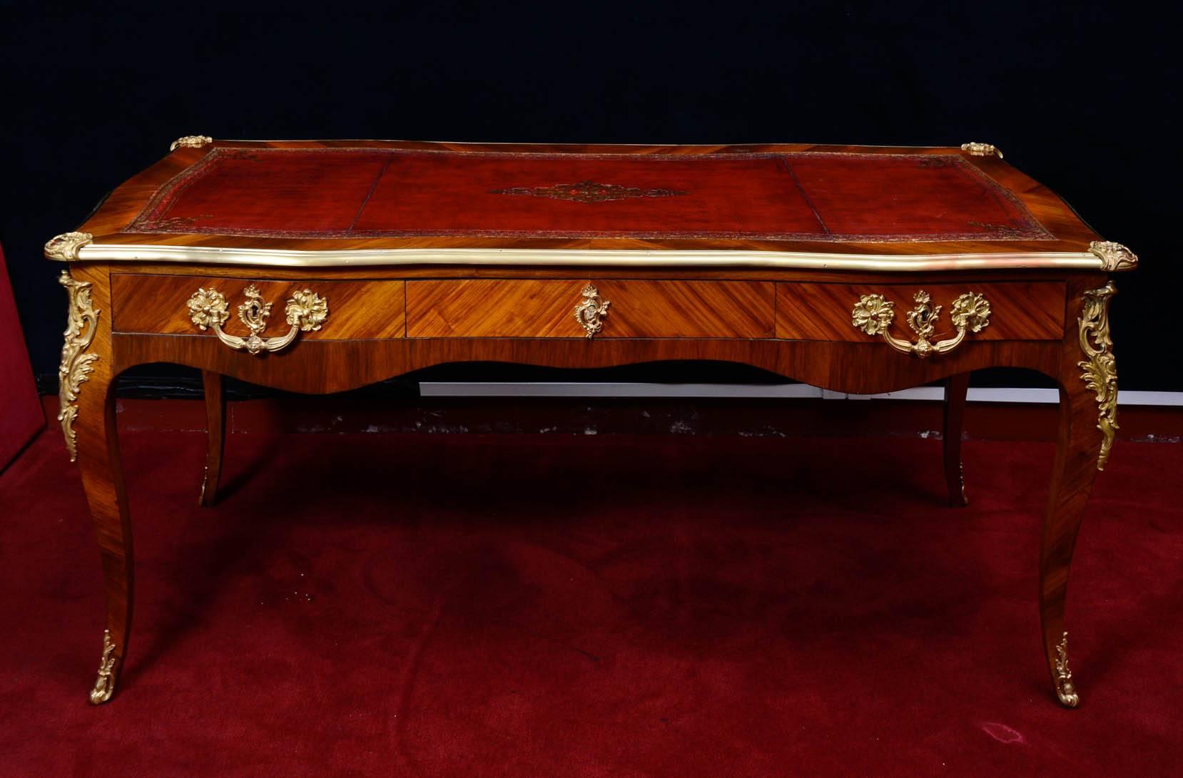 Writing desk, style Louis XV, early 19th century, gold gilt bronze mounts, exotic wood inlays with a leather embossed writing surface.
 