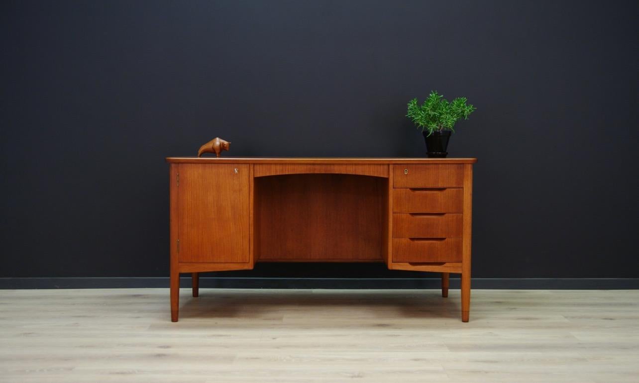 Fantastic desk, Danish design from the 1960s-1970s. The whole veneered with teak. The furniture has four drawers and roomy chests with doors, behind which there is a shelf. A book shelf at the back. The key in the set. Preserved in good condition