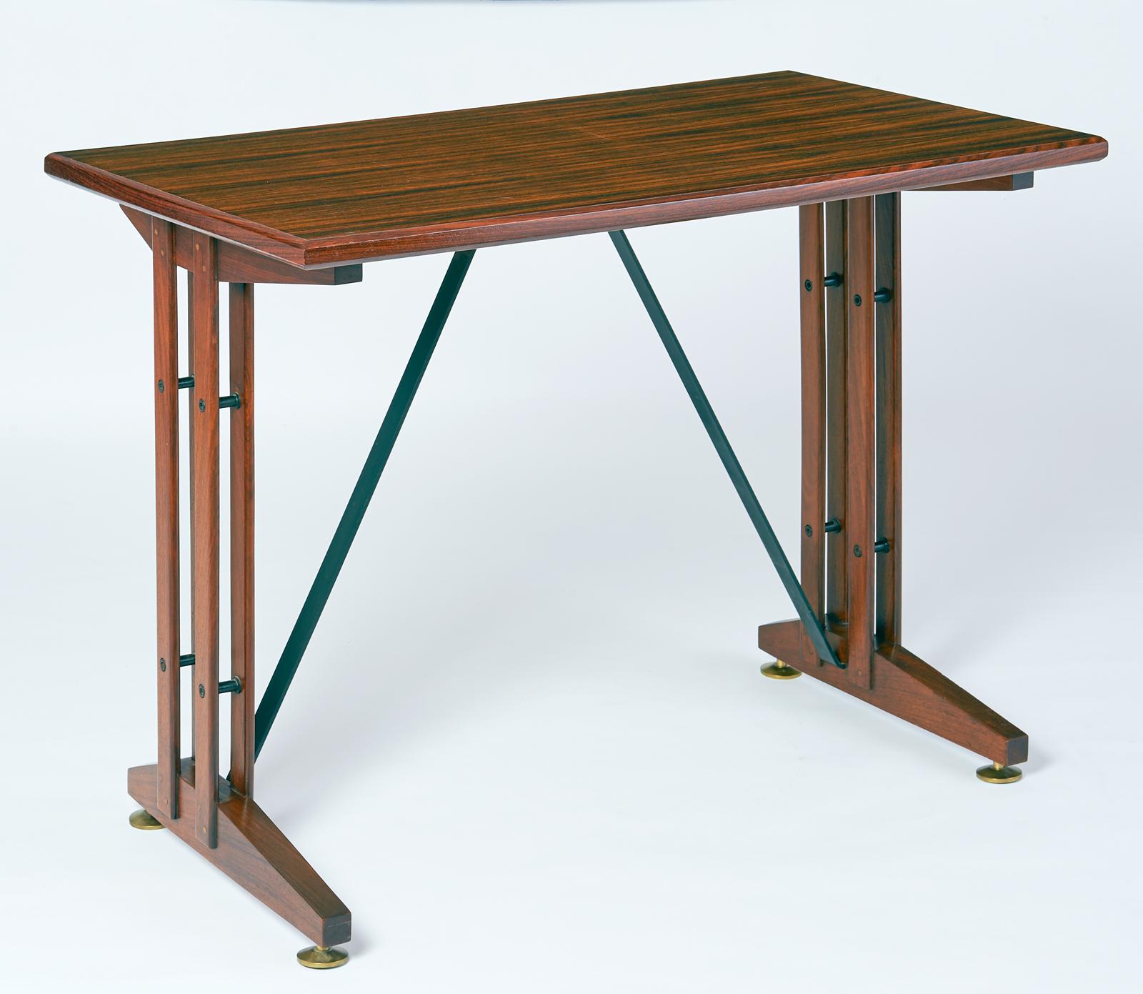 An elegant and compact writing or laptop  table, in polished wood with black iron stretchers and bronze adjusting feet. The perfect setting for a laptop,
Italy, 1950s
Dimensions: 39 x 22 x 30 H.
